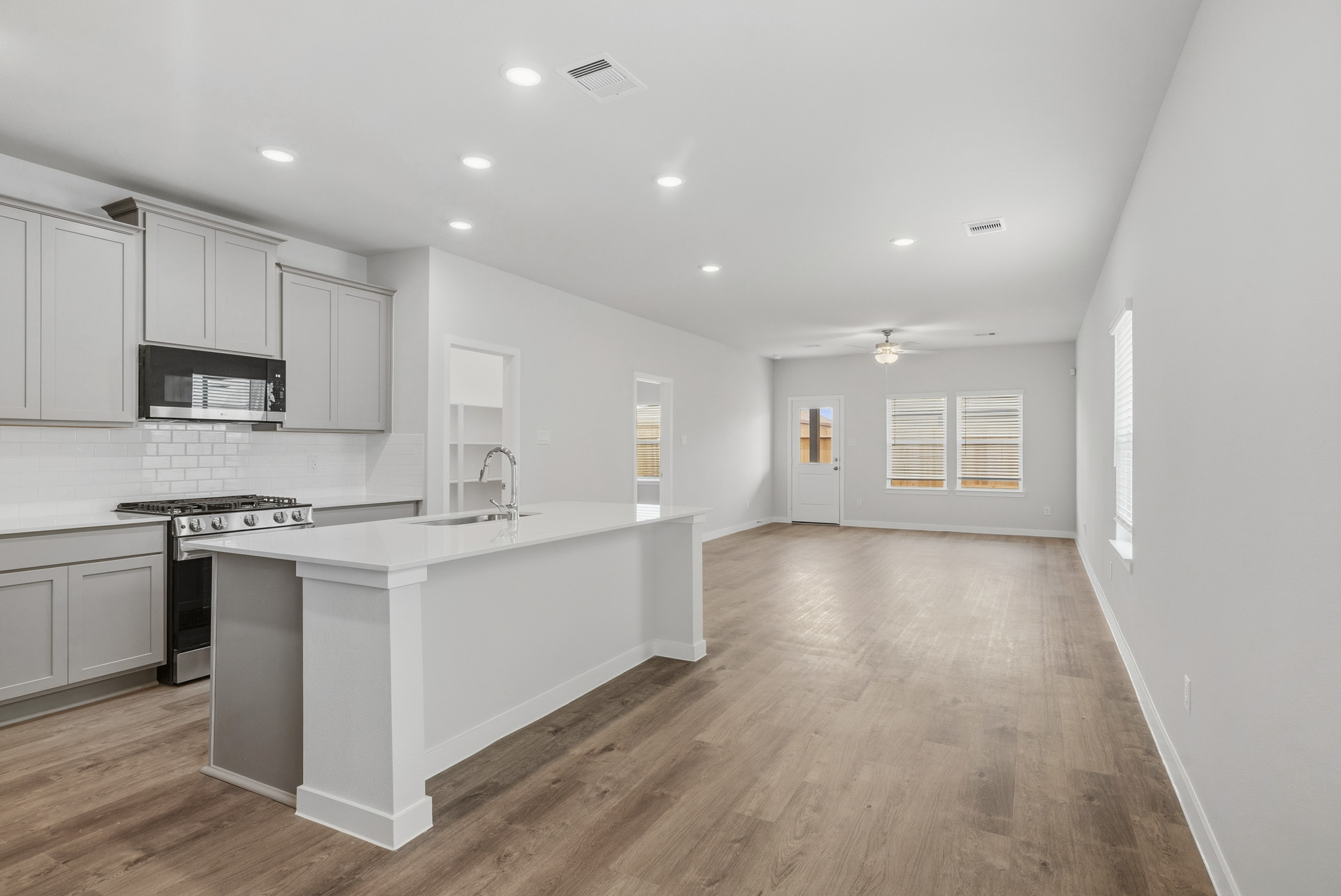 A kitchen with white cabinets.