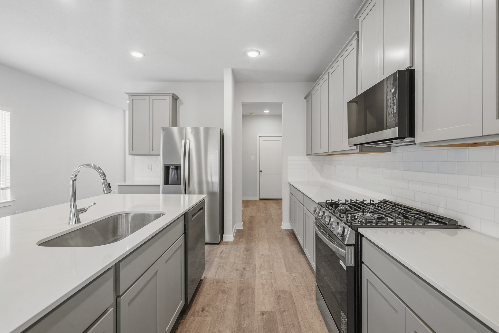 A kitchen with white cabinets.