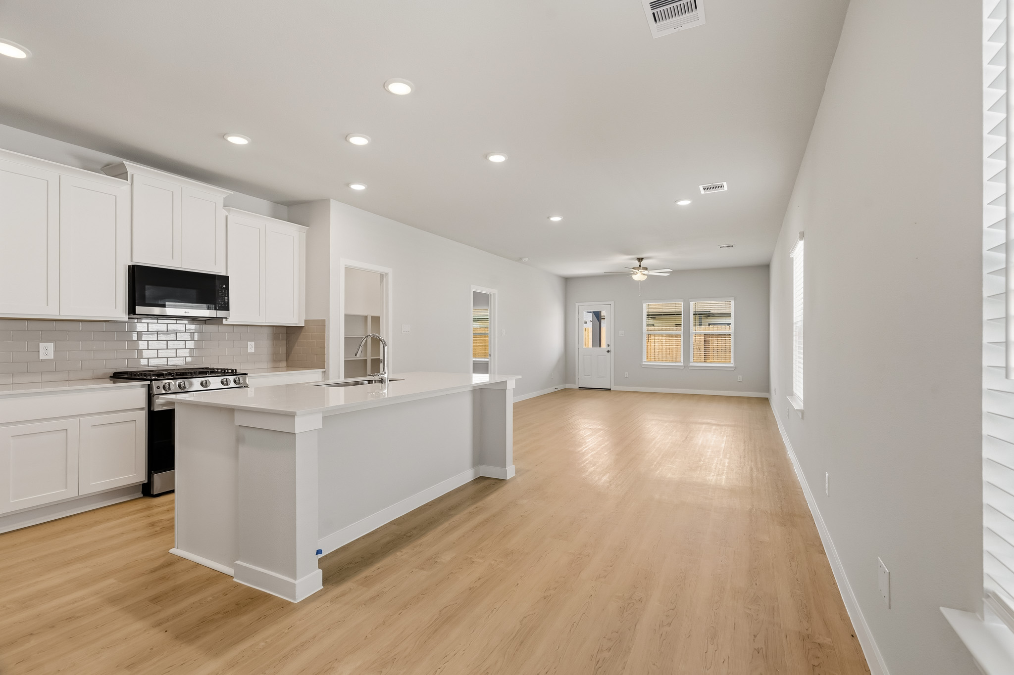 A kitchen with white cabinets.