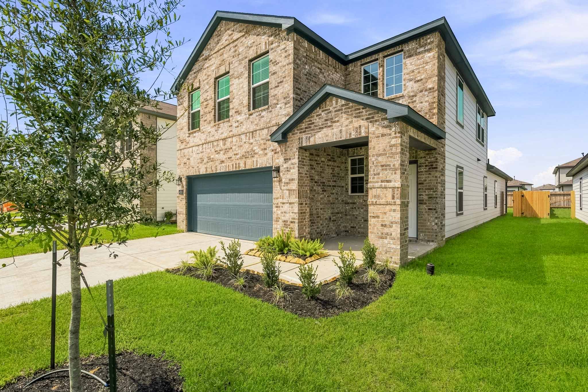 A brick building with a green lawn.