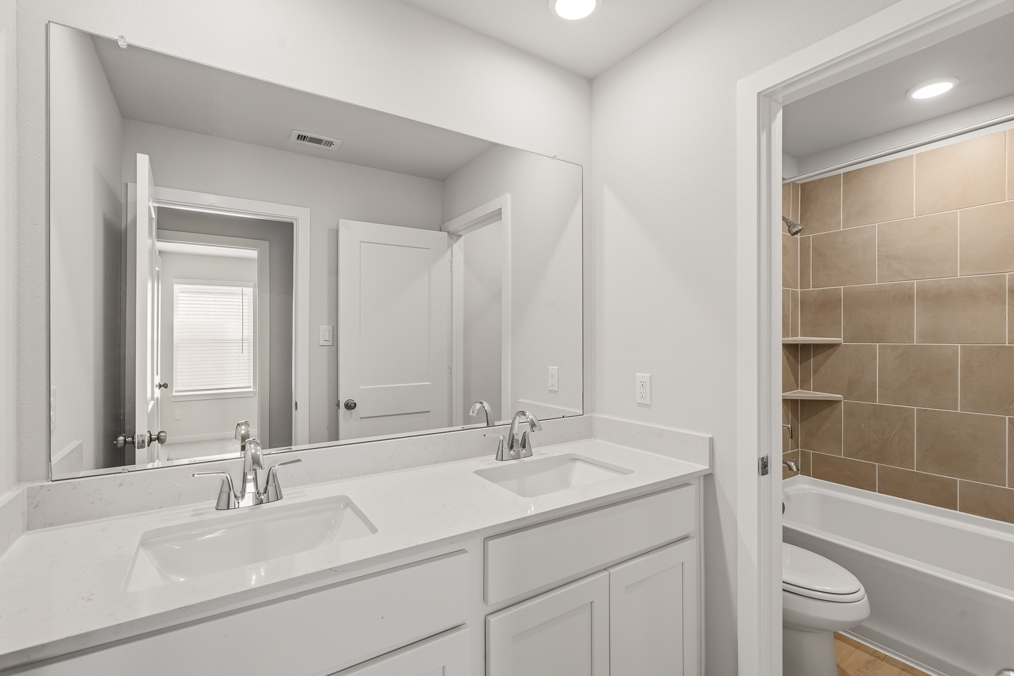 A bathroom with a tub sink and toilet.