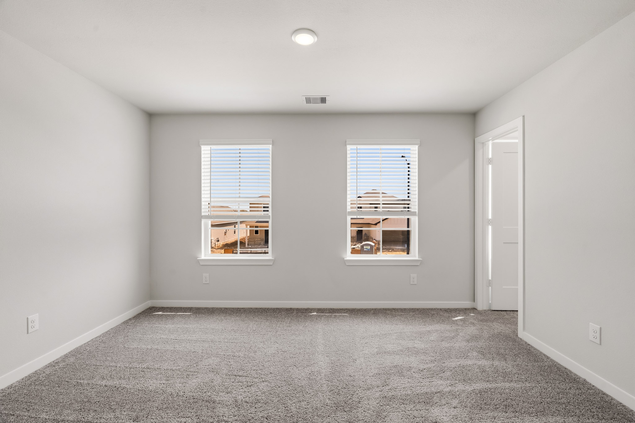 A room with a window and a door.