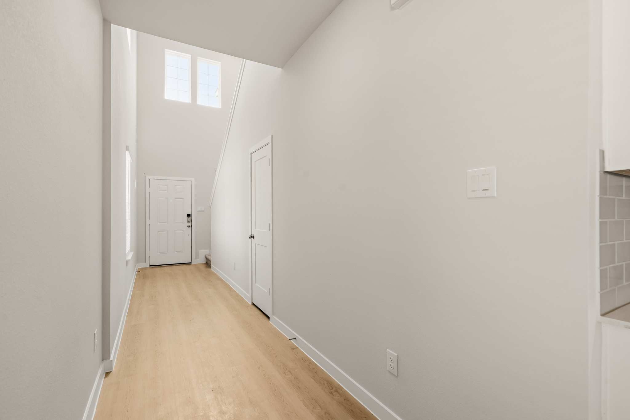 A hallway with white walls.