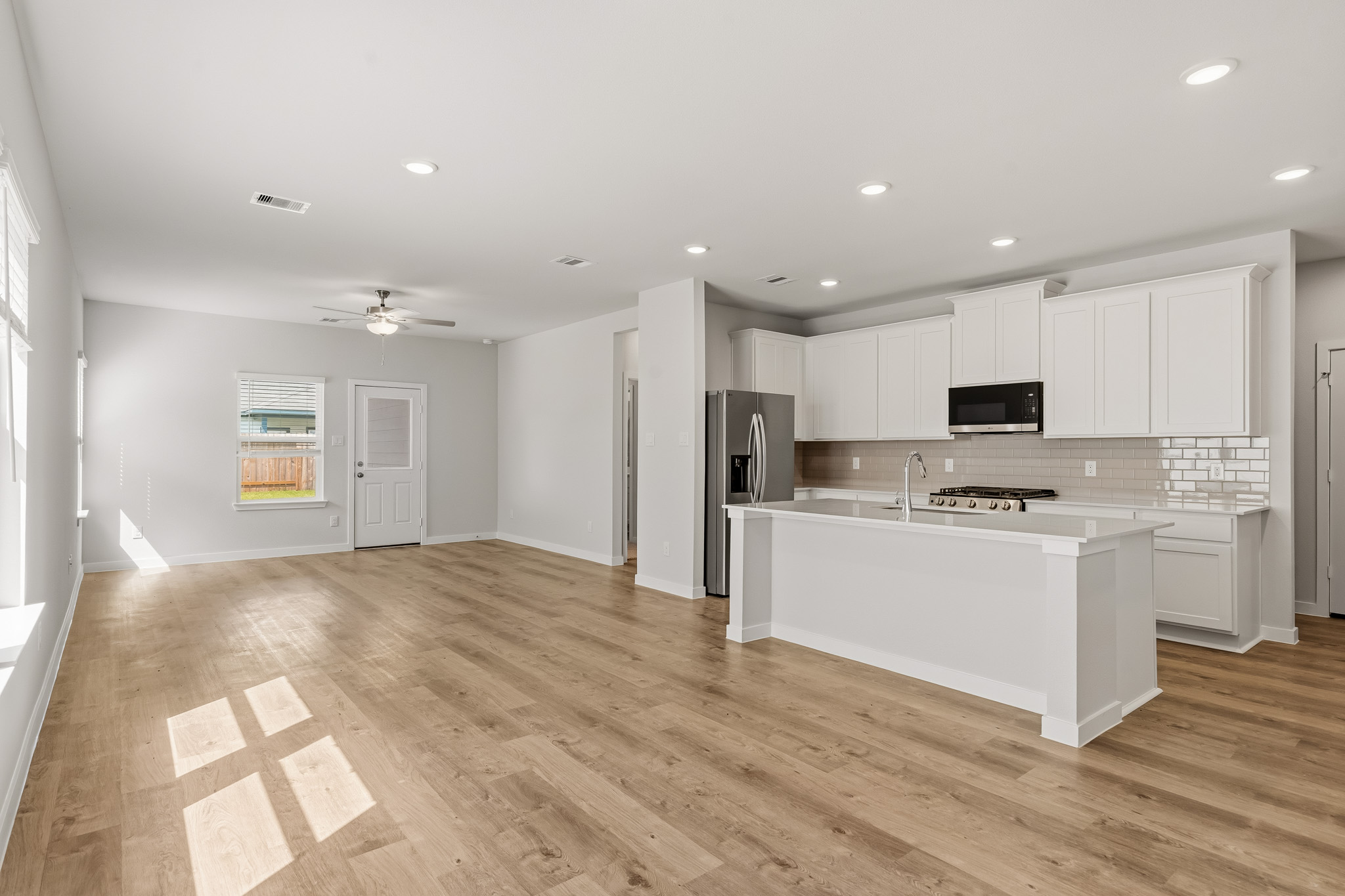 A kitchen with white cabinets.