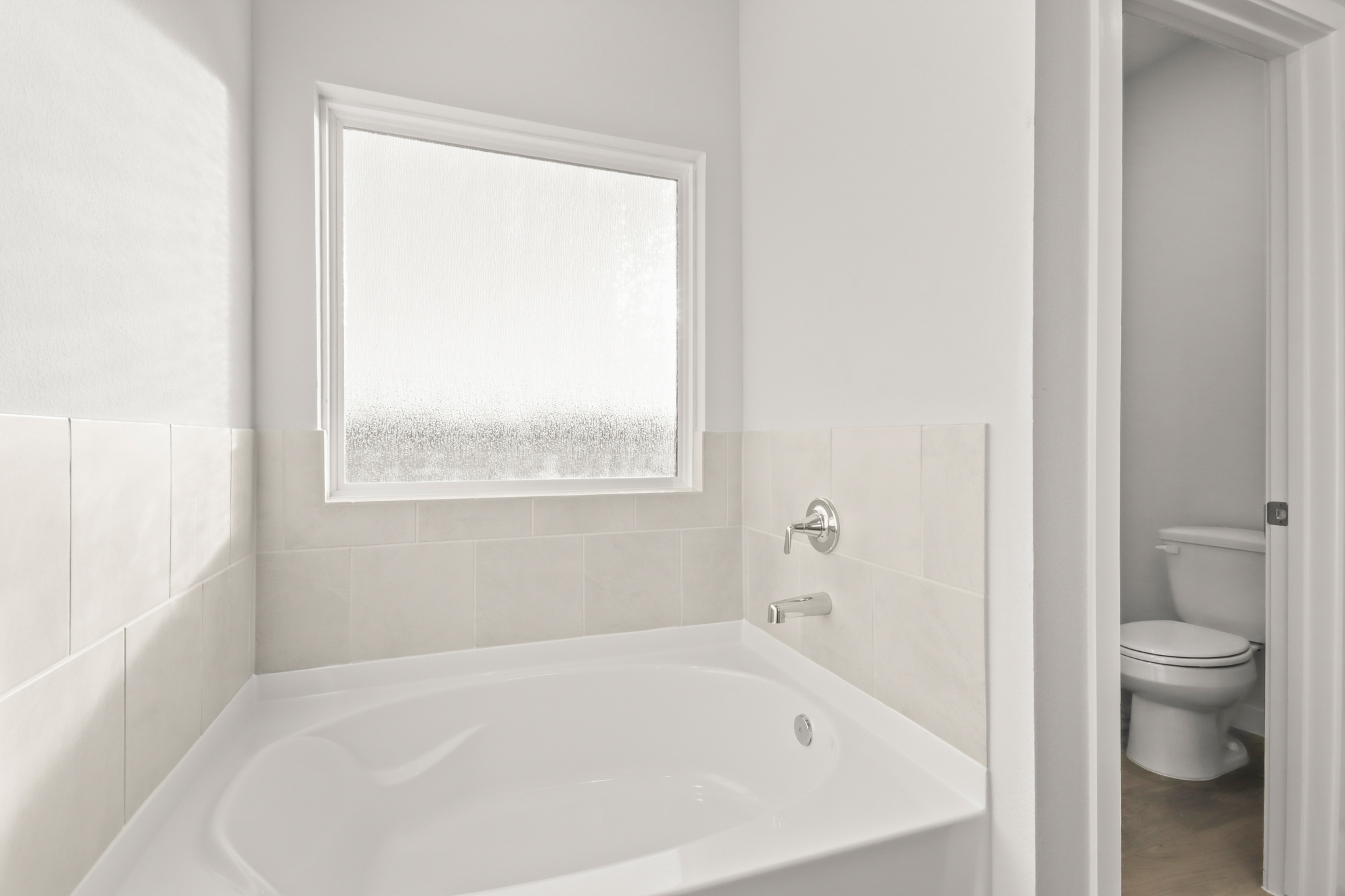 A bathtub in a bathroom.