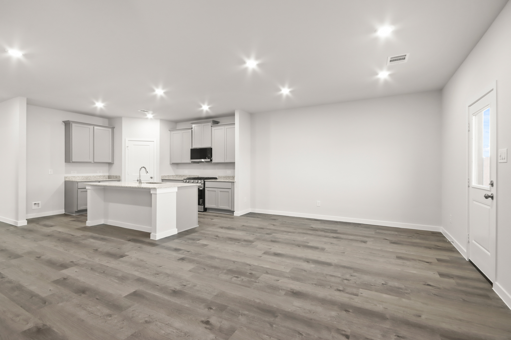 A kitchen with white cabinets.