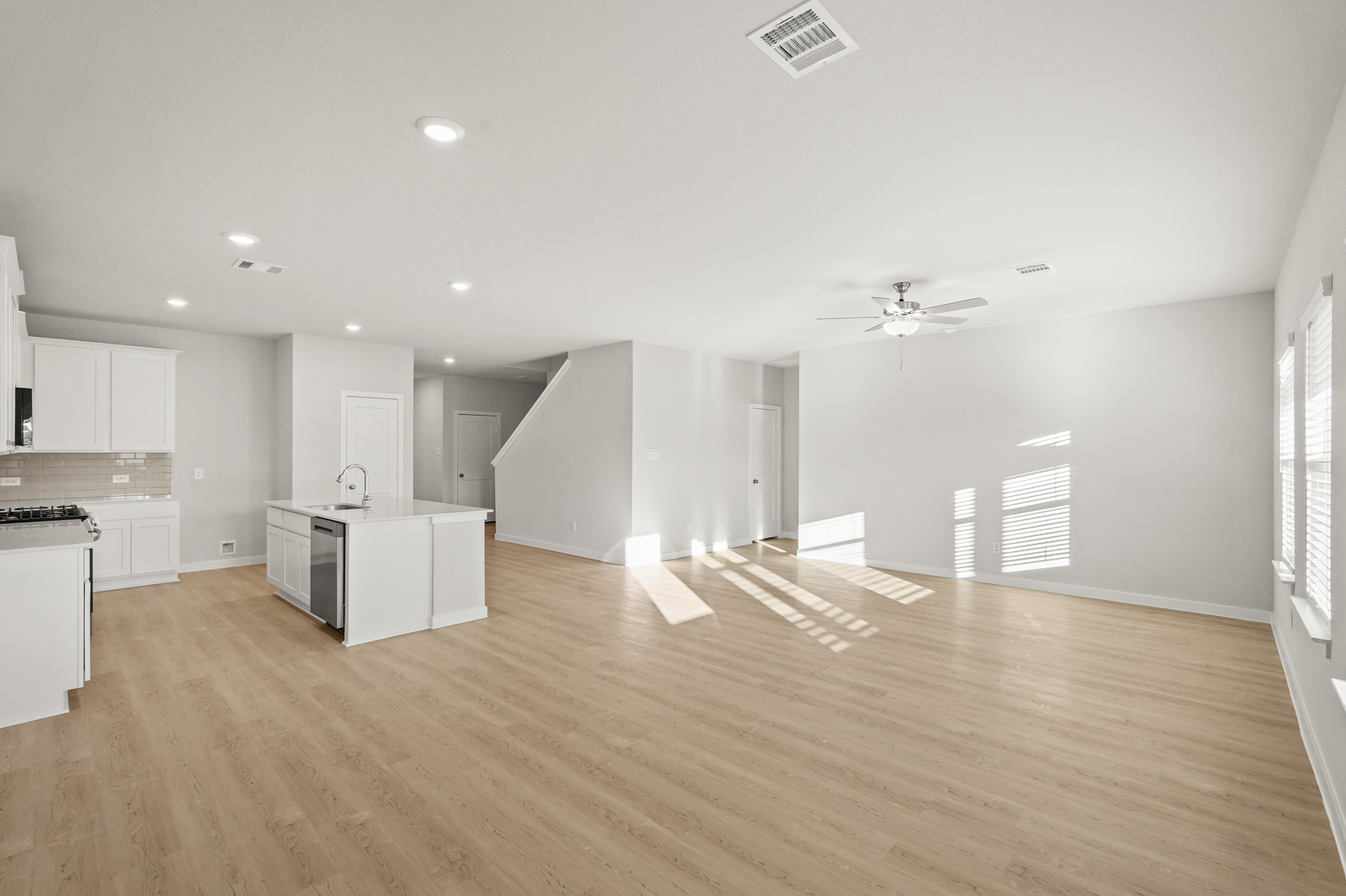 A large kitchen with white cabinets.
