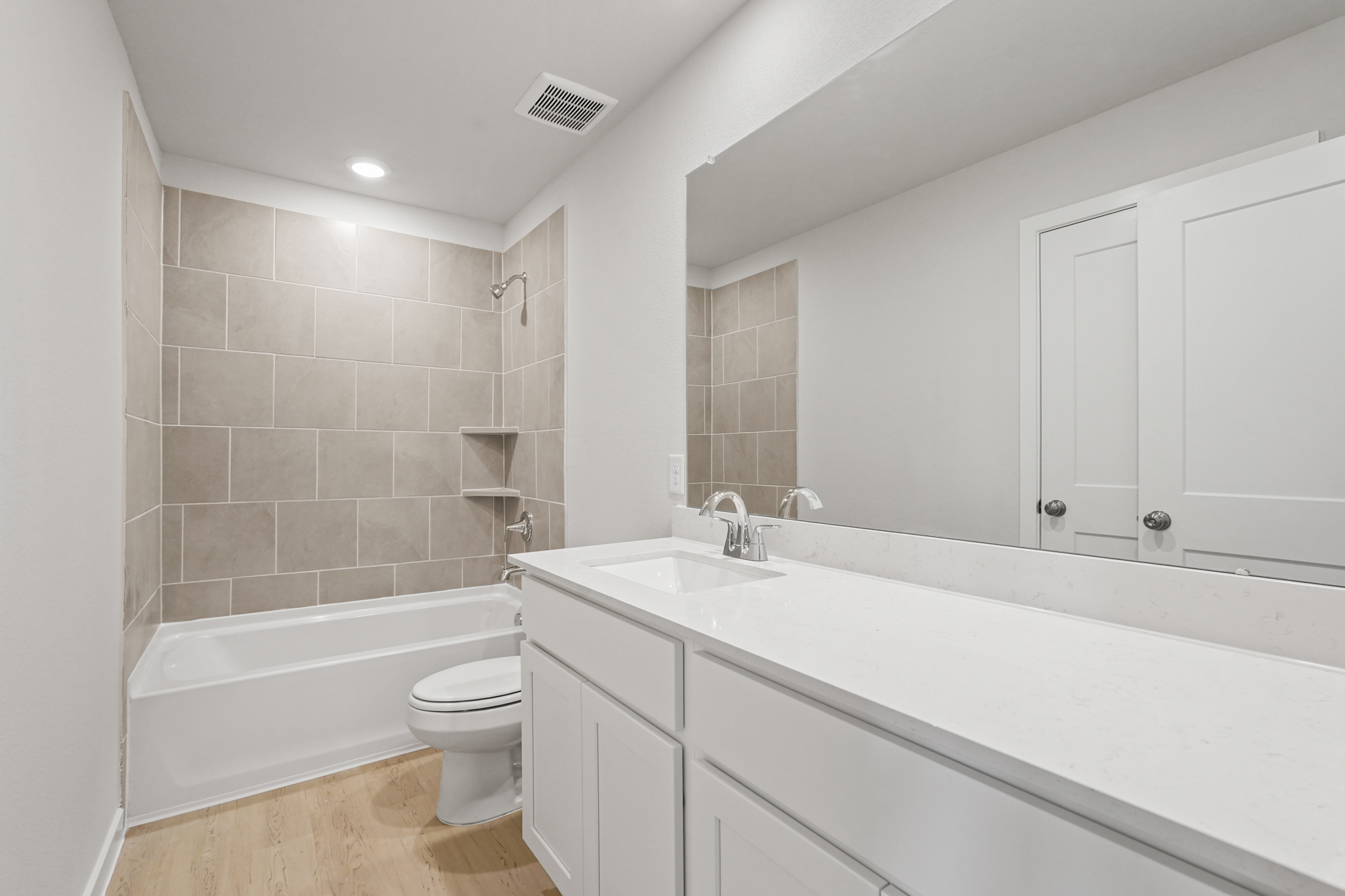 A bathroom with a tub toilet and sink.
