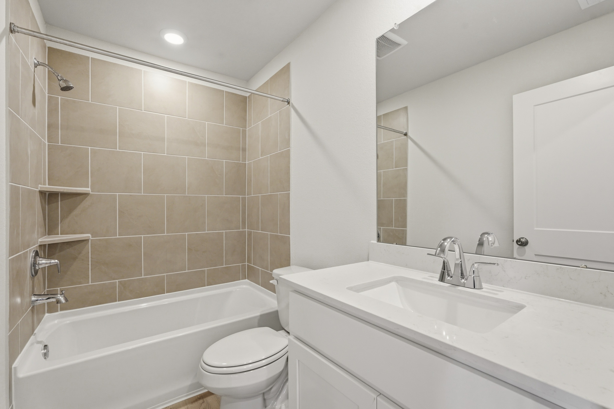 A bathroom with a tub sink and toilet.