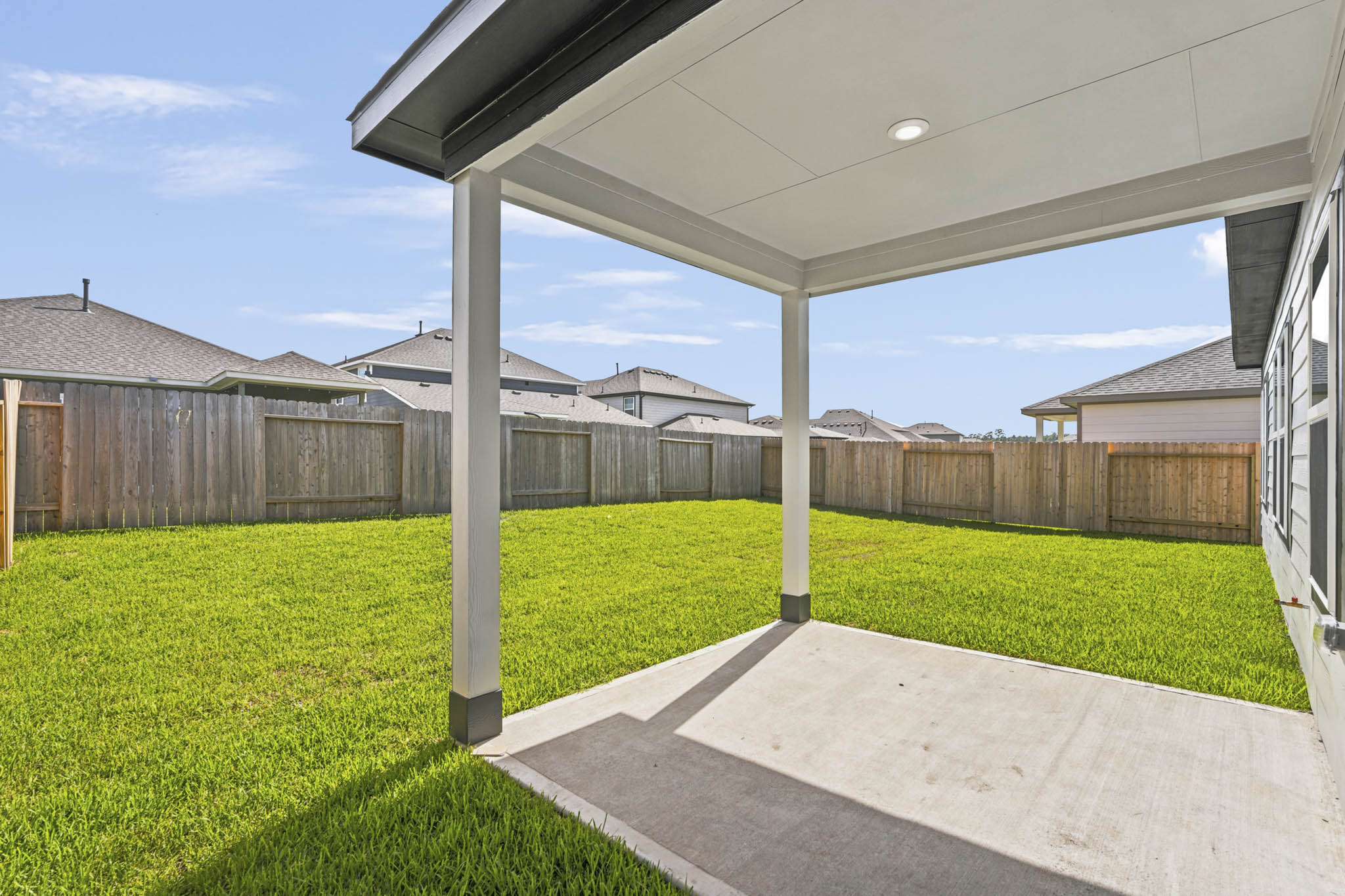 A fenced in yard with a walkway and a walkway.