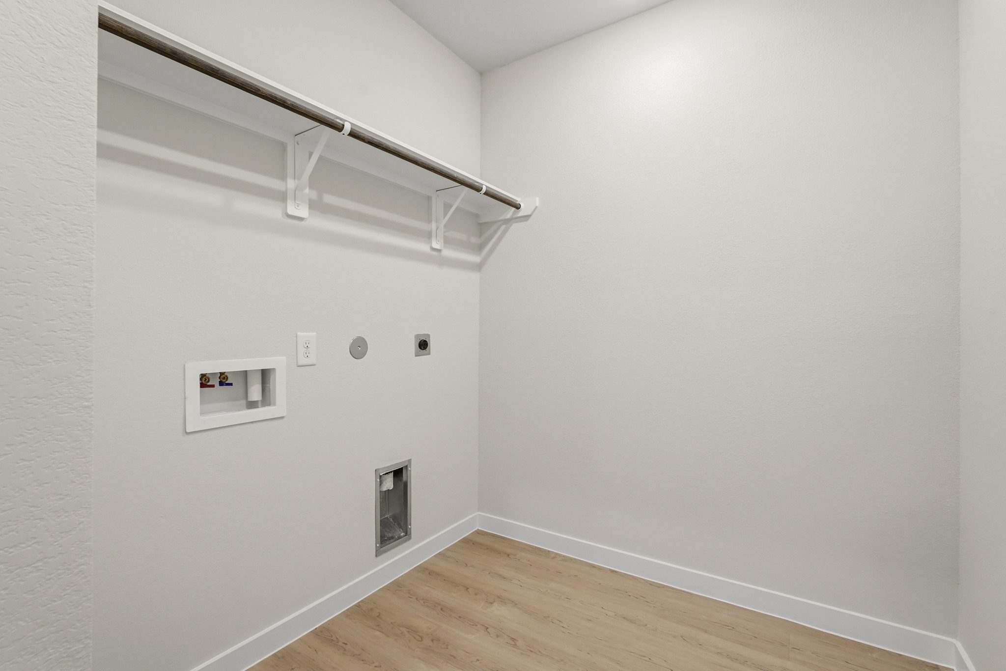 A white room with a wood floor and a white ceiling.