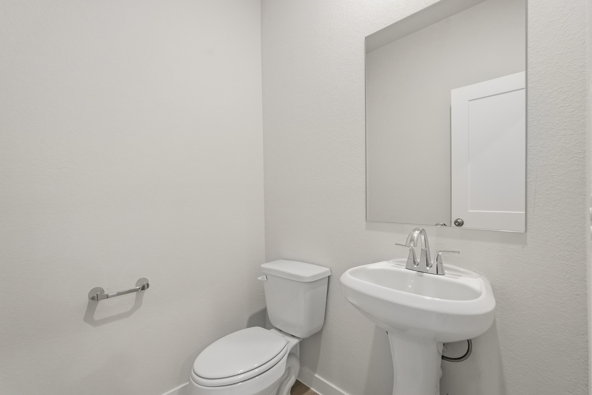 A bathroom with a toilet and sink.