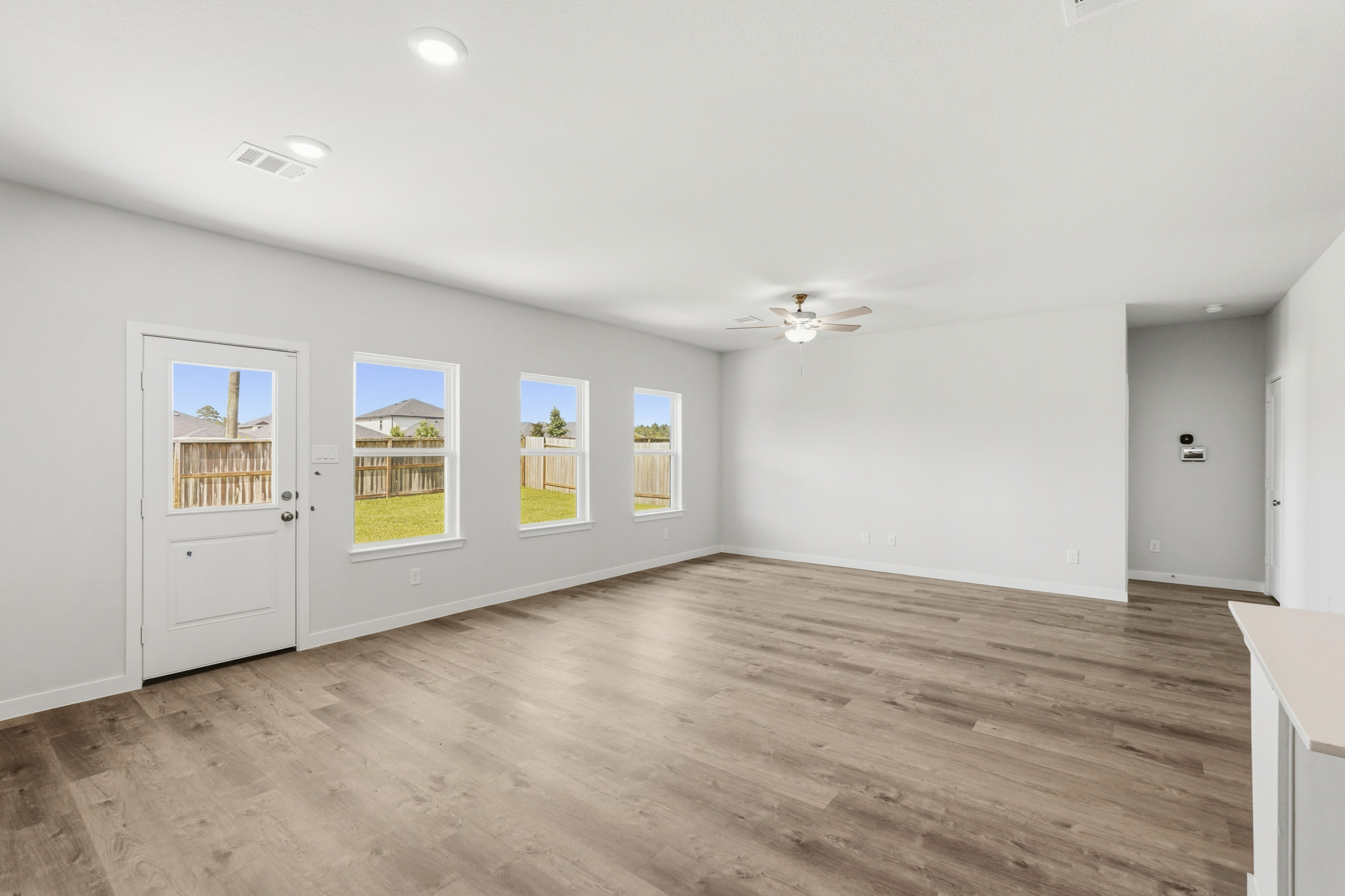 A room with a wood floor and white walls.