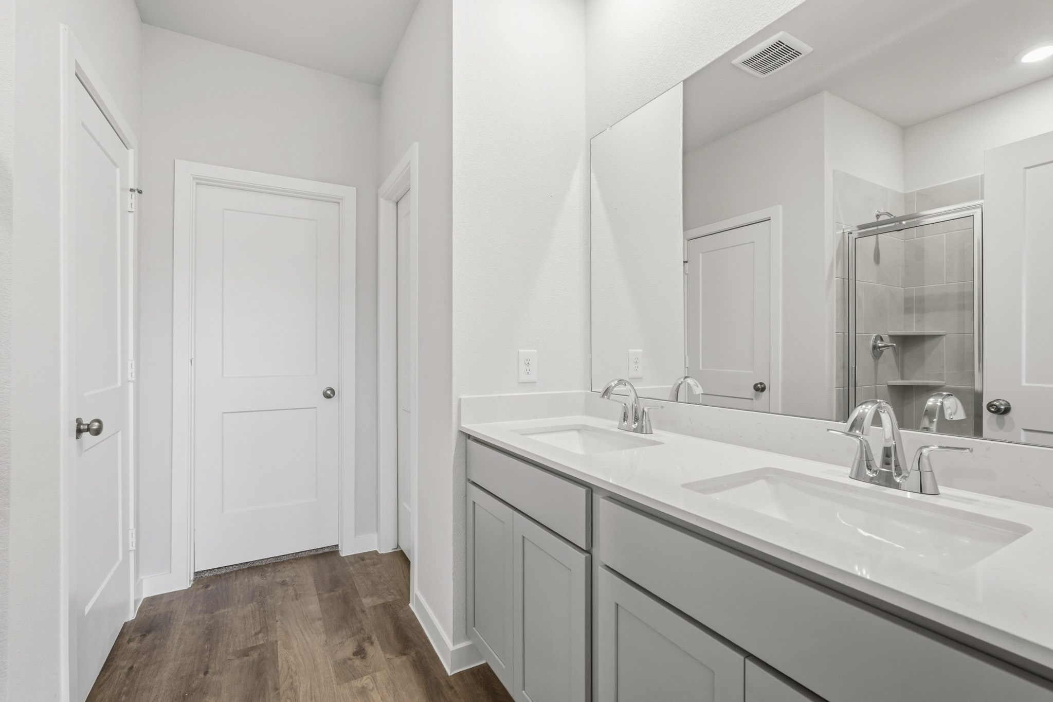 A bathroom with a large mirror.