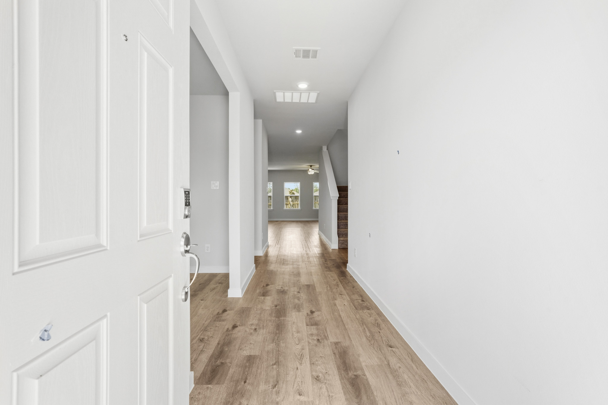 A hallway with white doors.