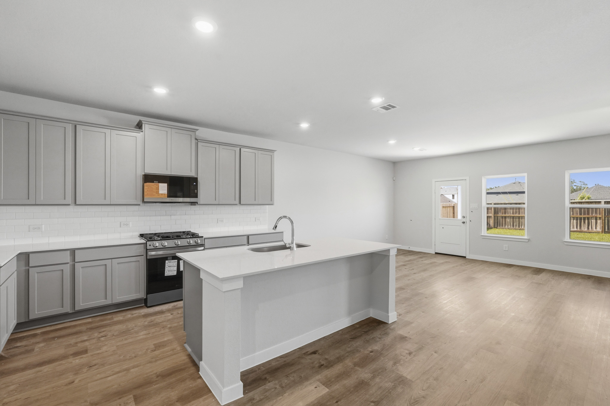 A kitchen with white cabinets.