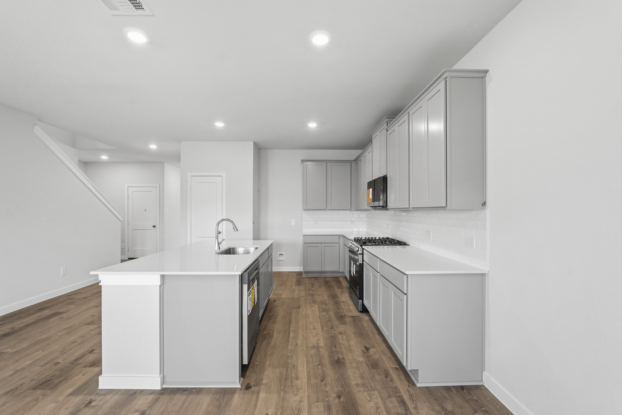 A kitchen with white cabinets.