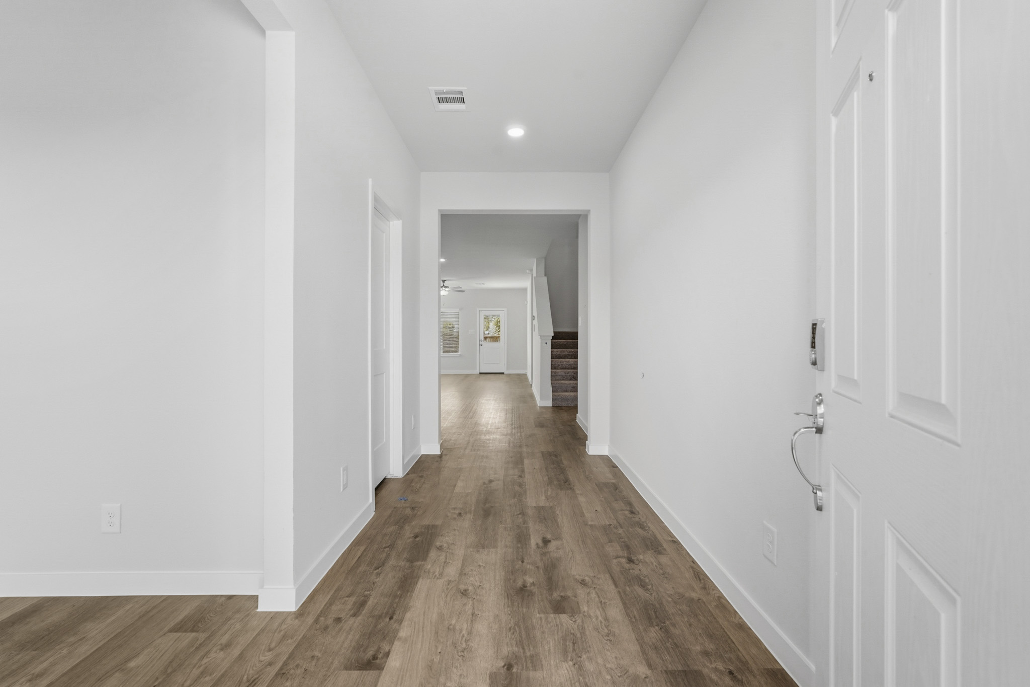 A hallway with white doors.