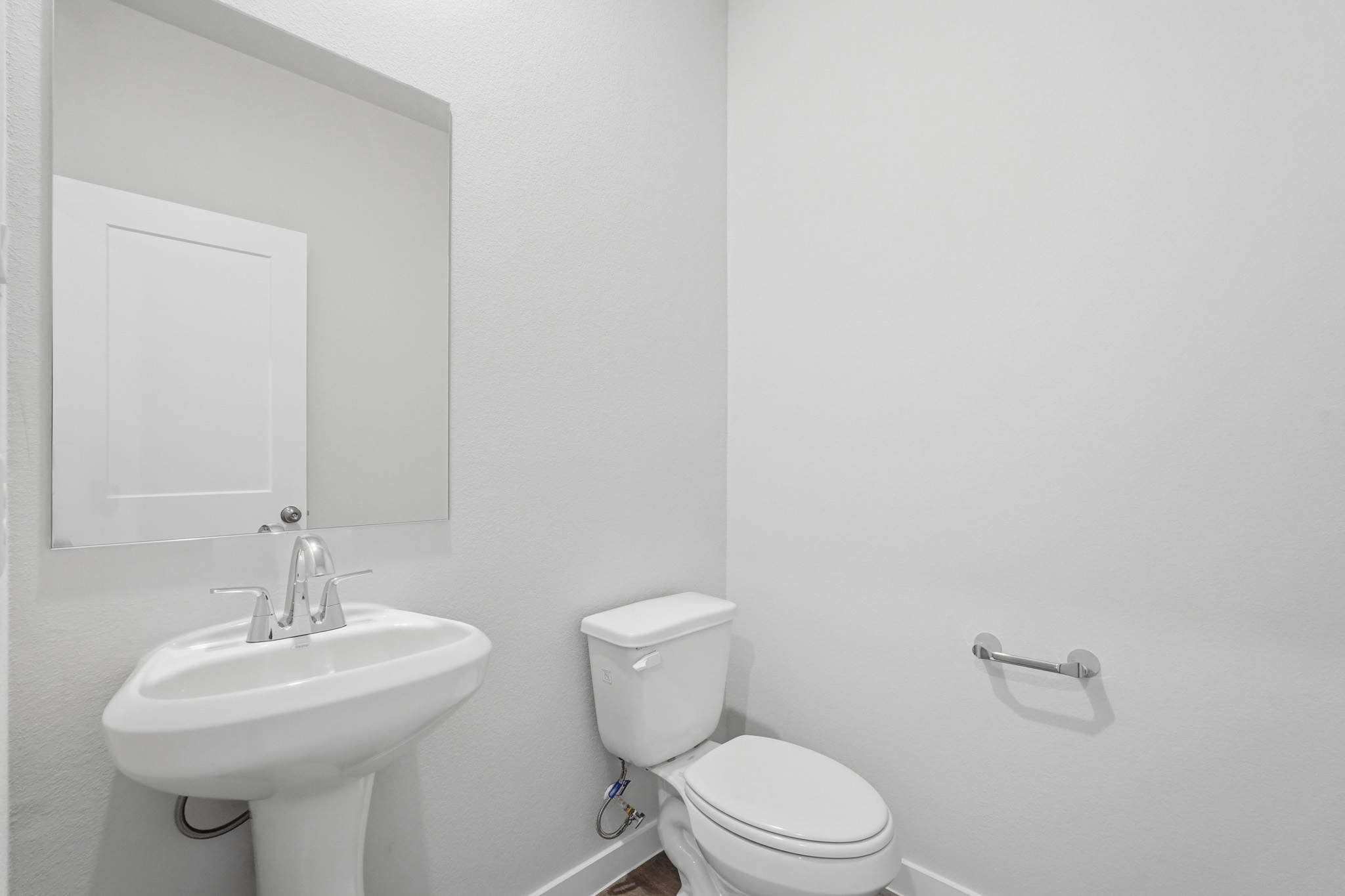A bathroom with a toilet and sink.