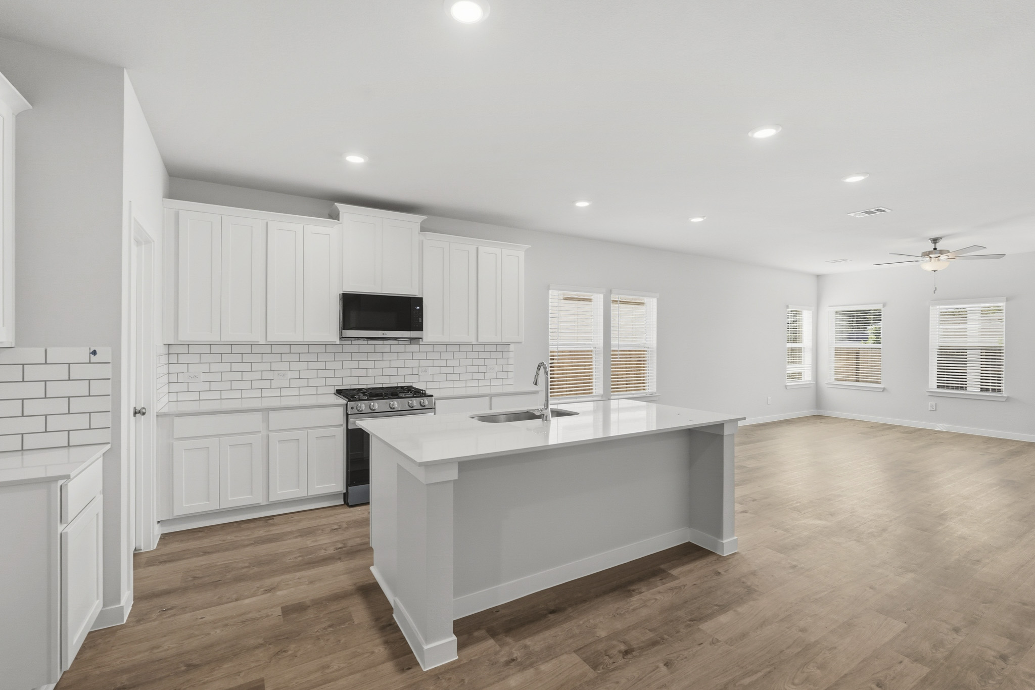 A kitchen with white cabinets.