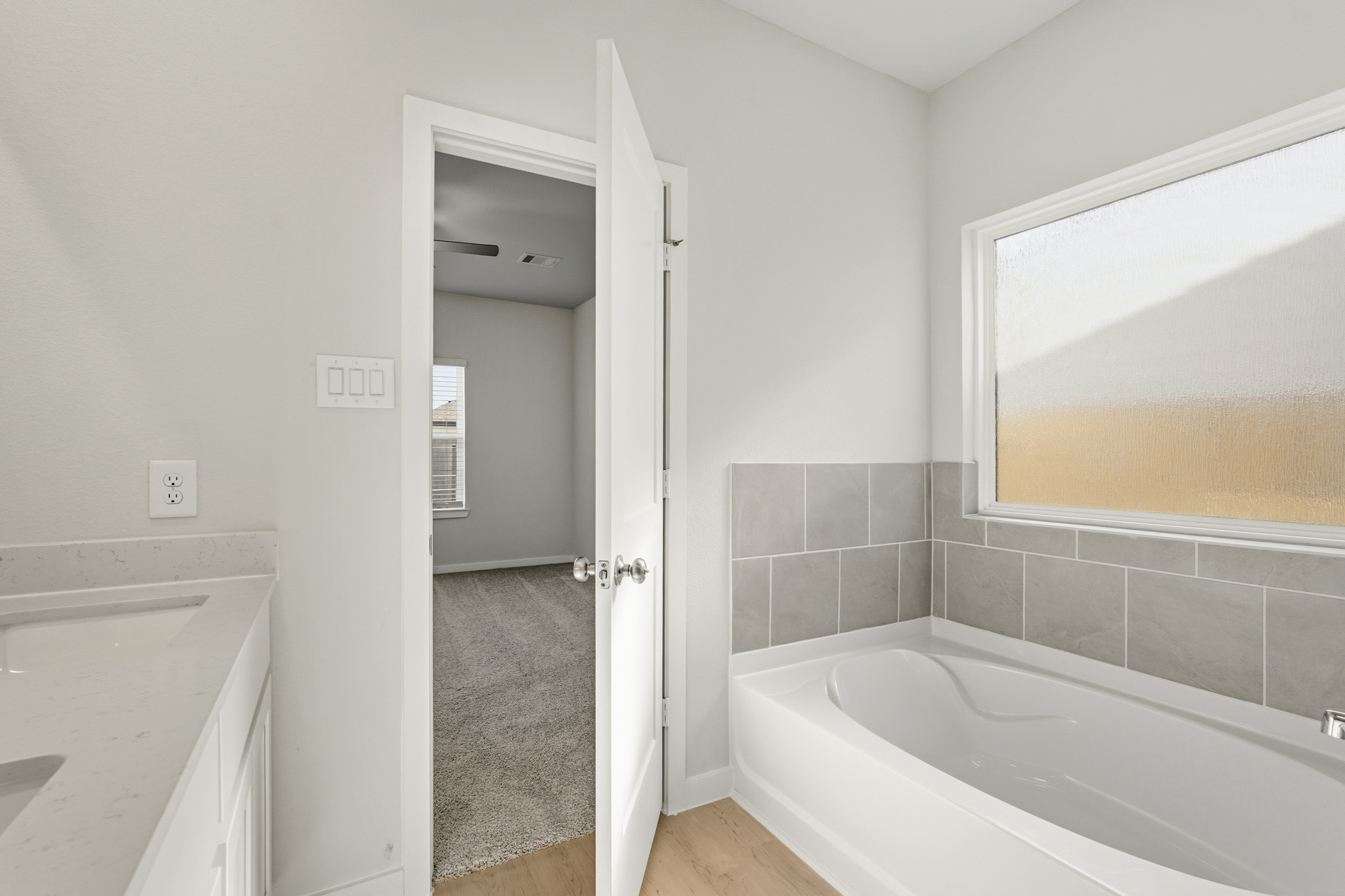 A bathroom with a bathtub and shower.