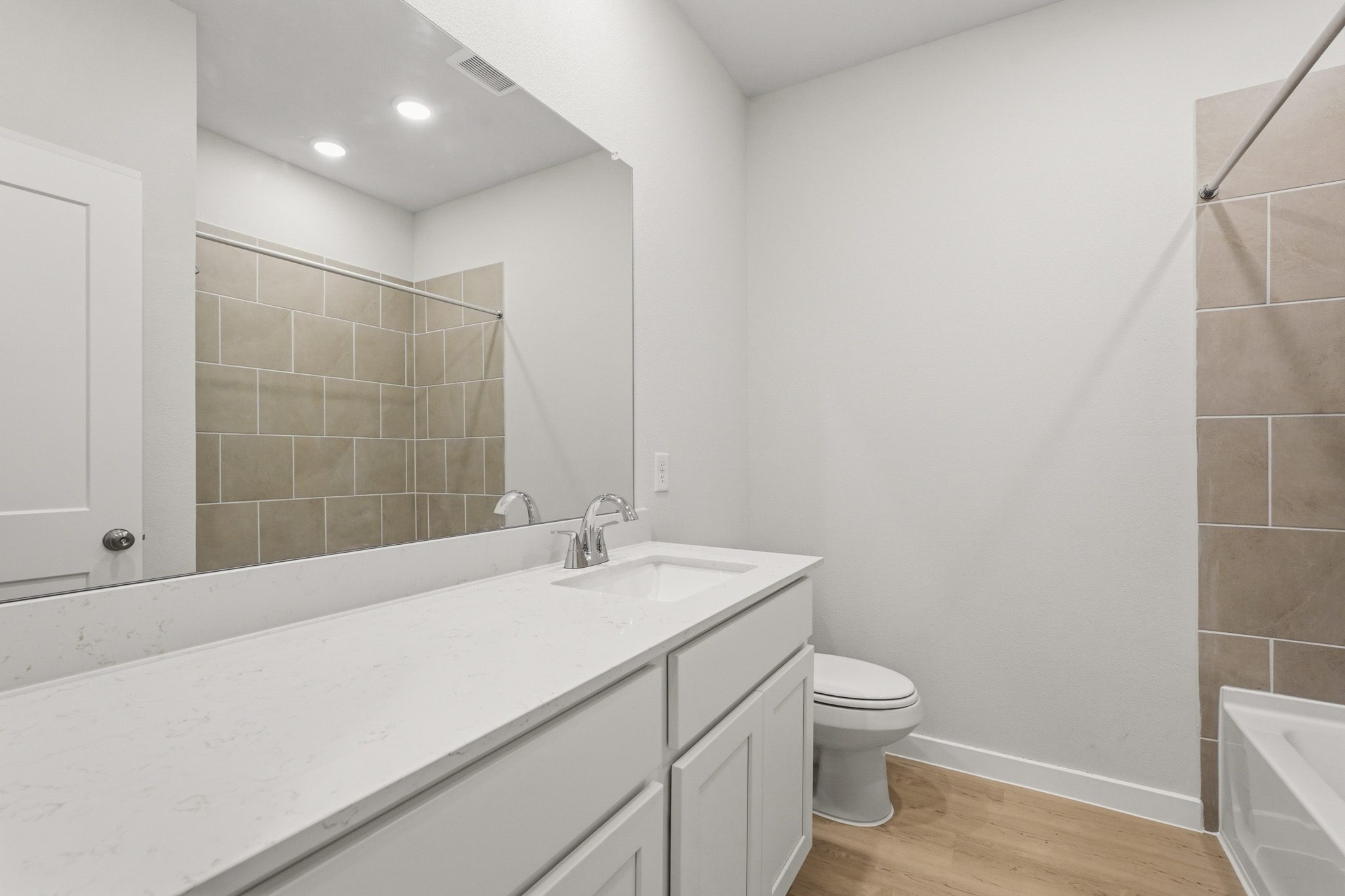 A bathroom with a tub sink and toilet.
