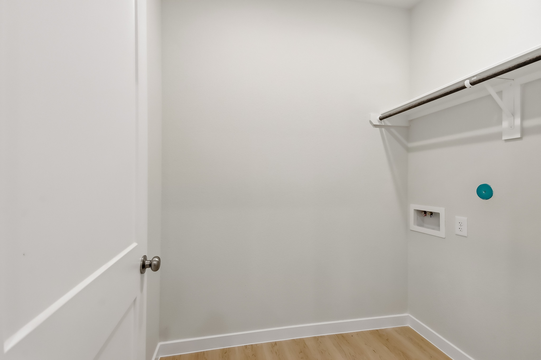 A white door with a green light.