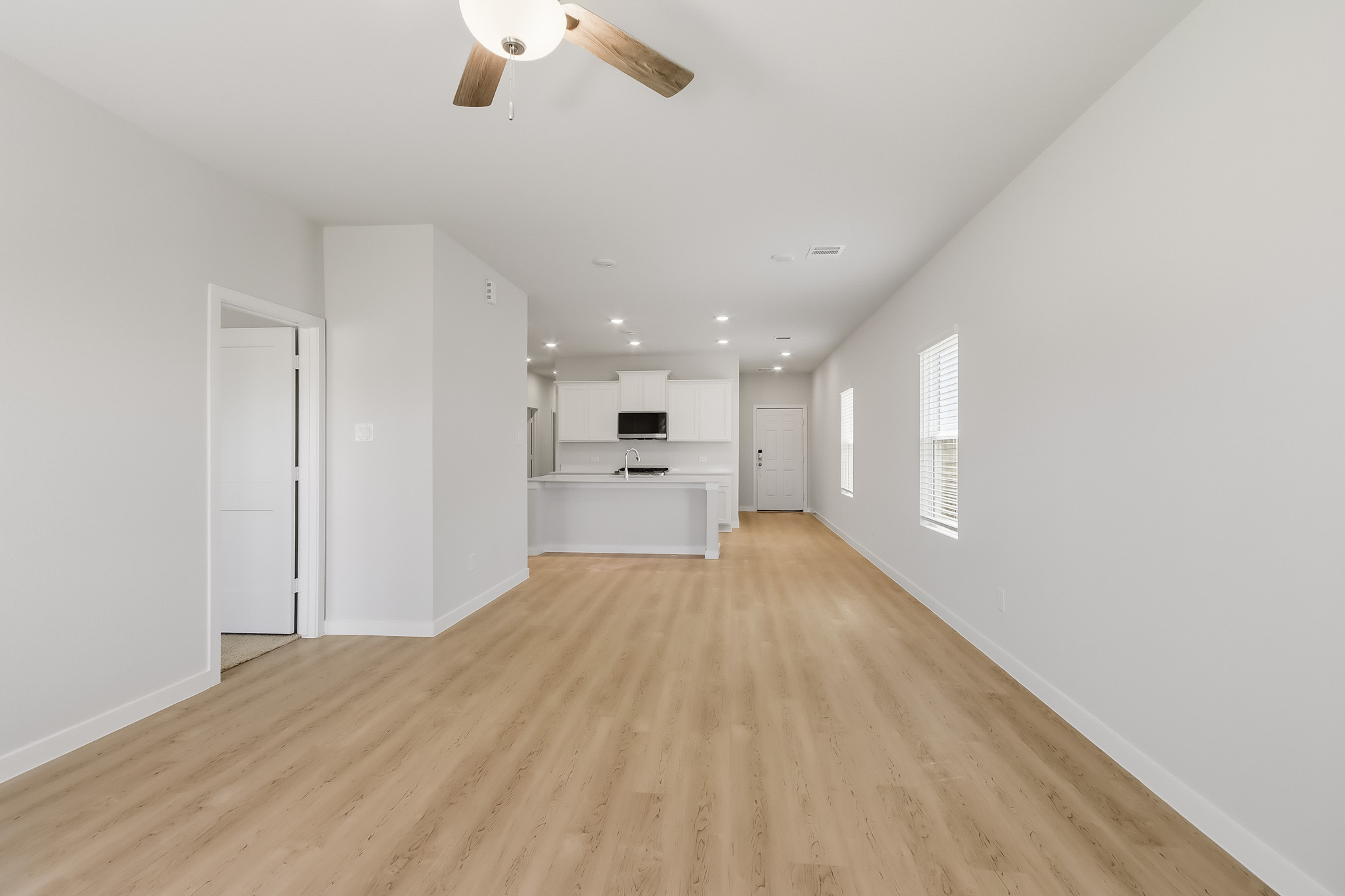 A room with white walls and a wood floor.