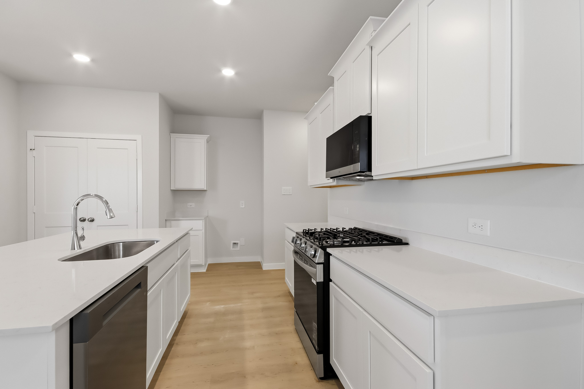 A kitchen with white cabinets.