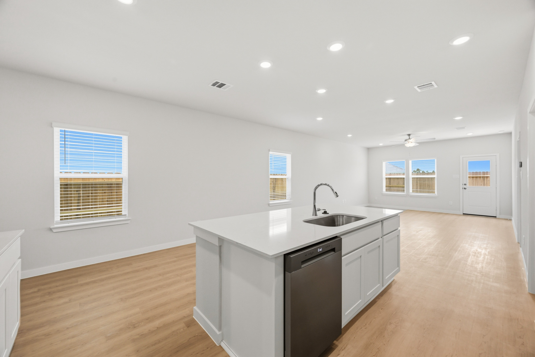 A kitchen with white cabinets.