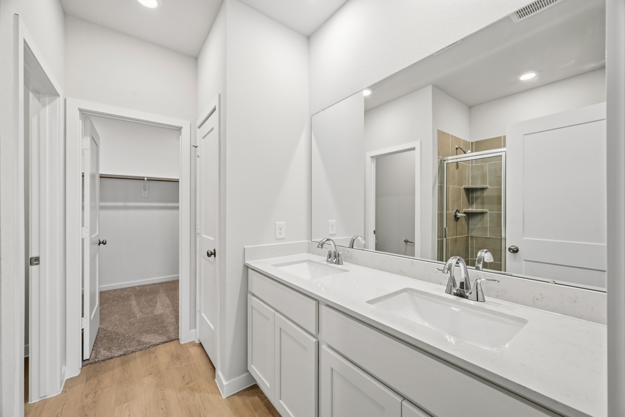 A bathroom with a large mirror.