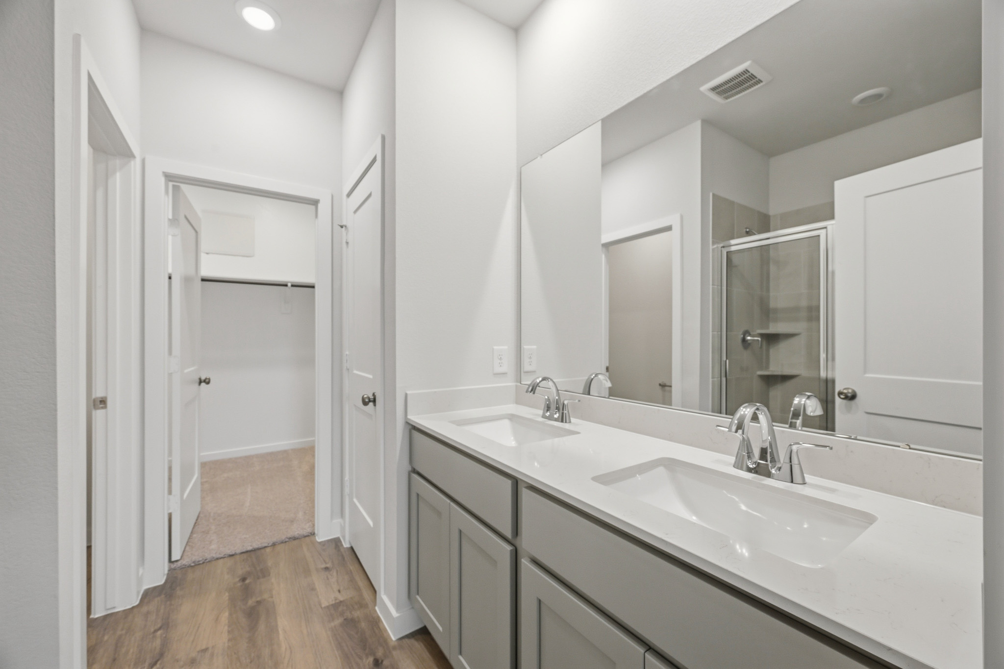 A bathroom with a large mirror.