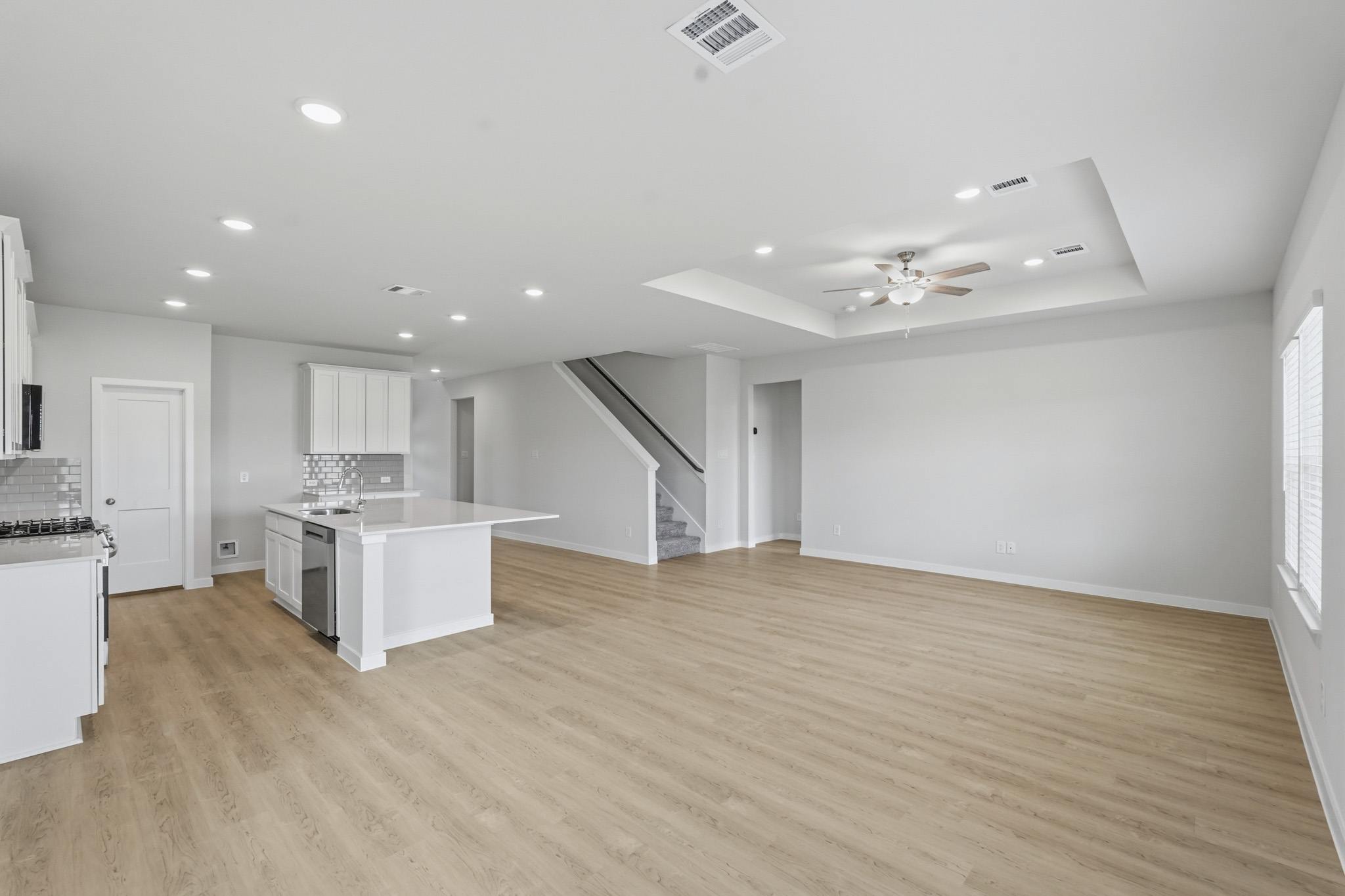 A large kitchen with white cabinets.