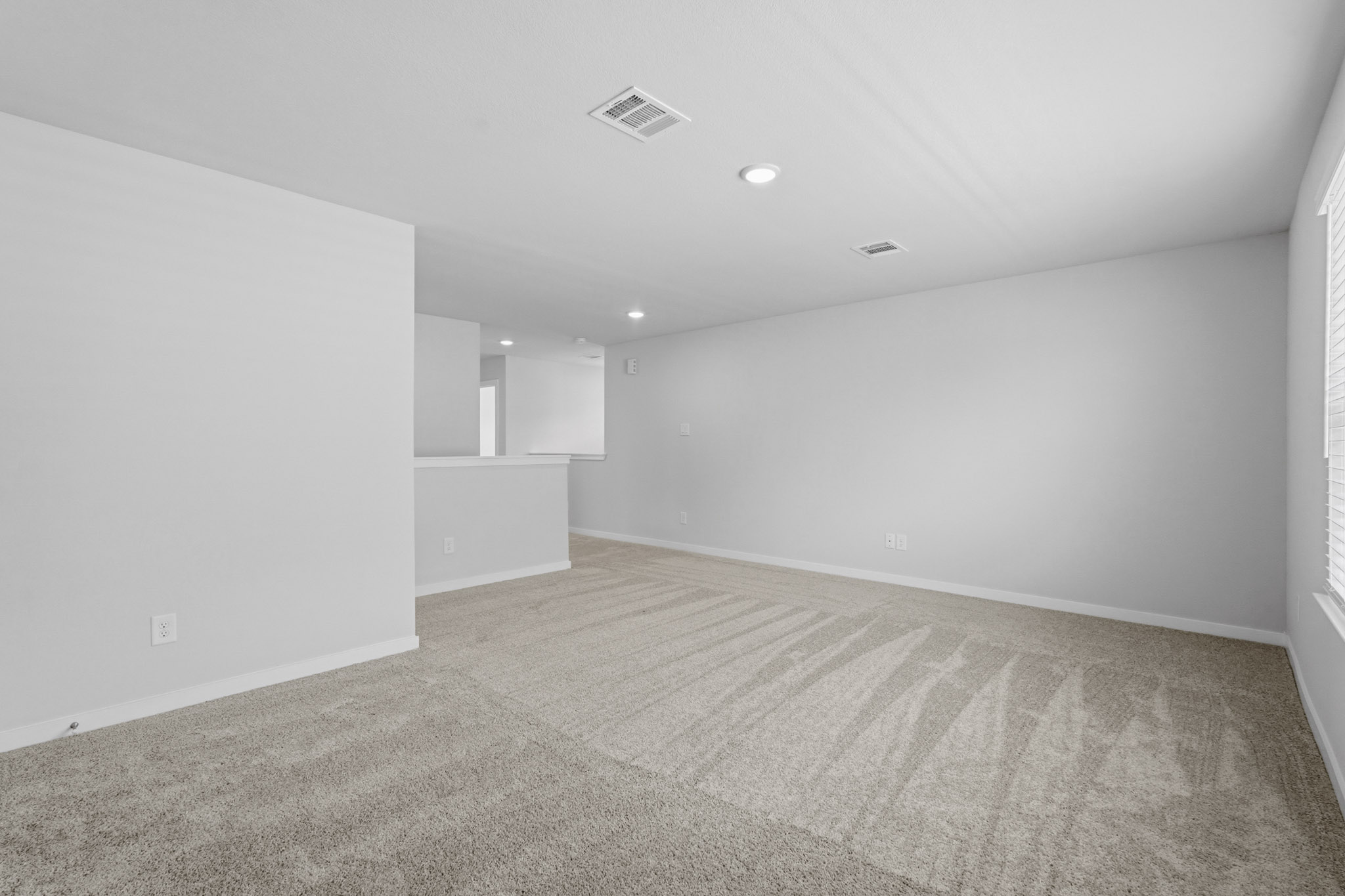 A long hallway with white walls.