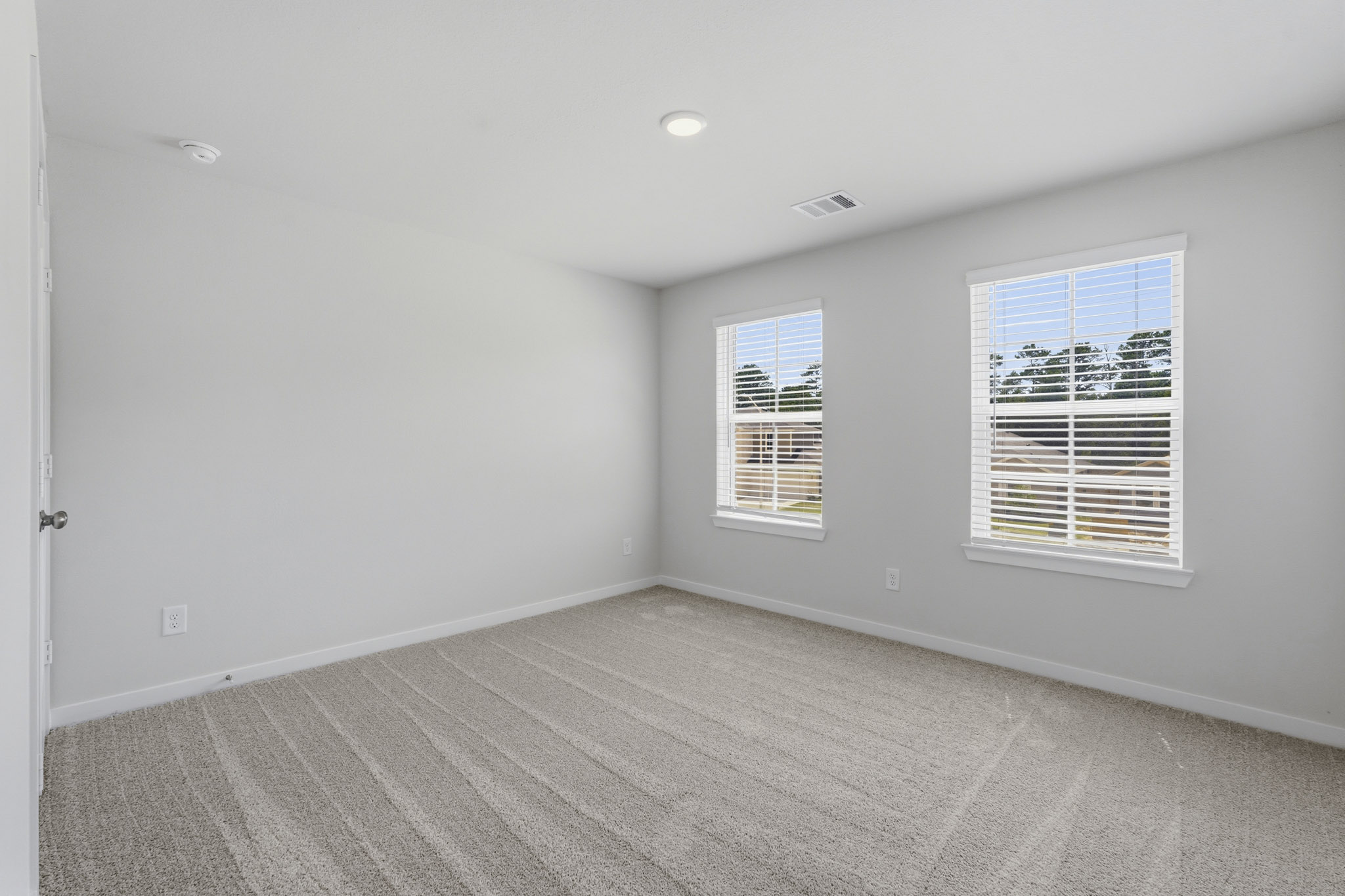 A room with a window and a door.