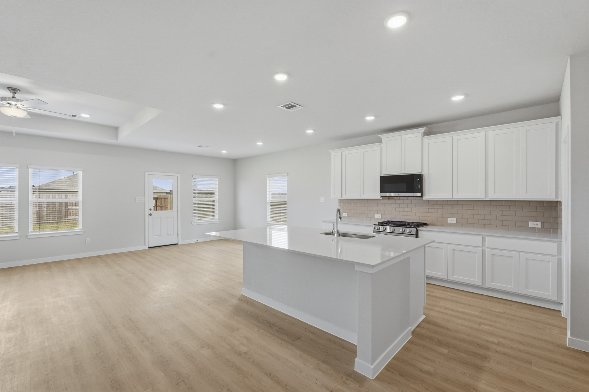 A kitchen with white cabinets.