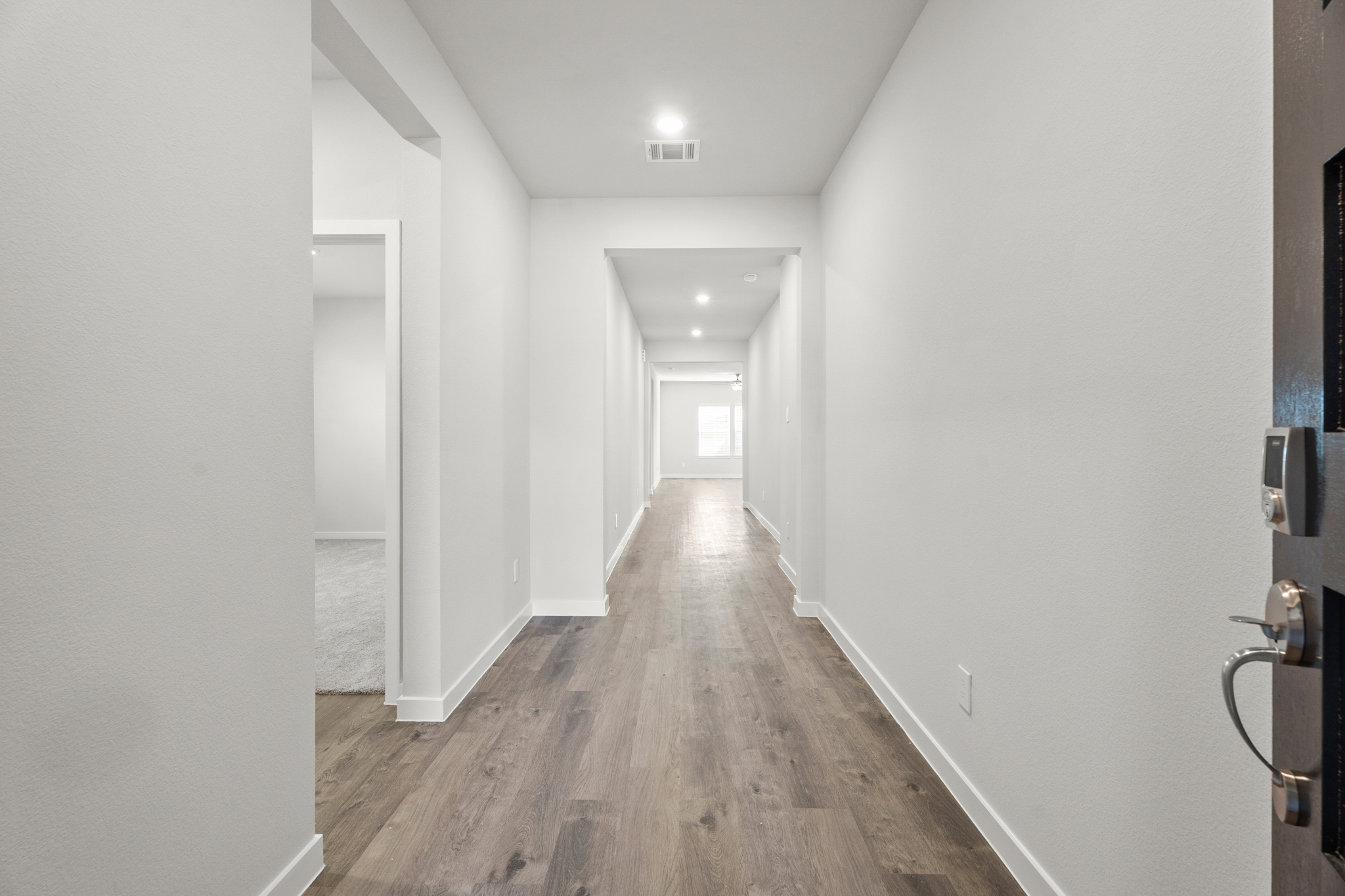 A long hallway with white walls.
