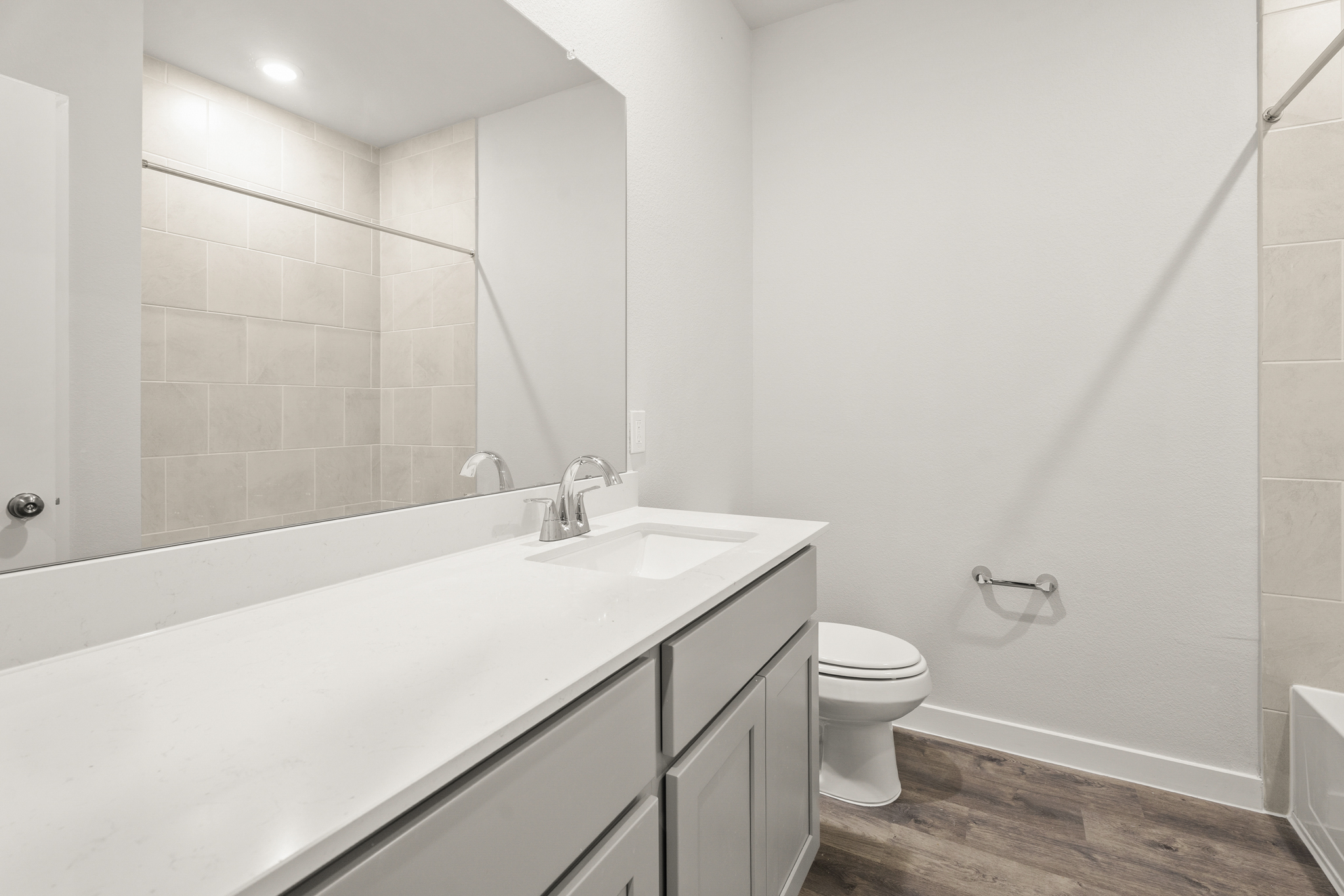 A bathroom with a tub sink and toilet.