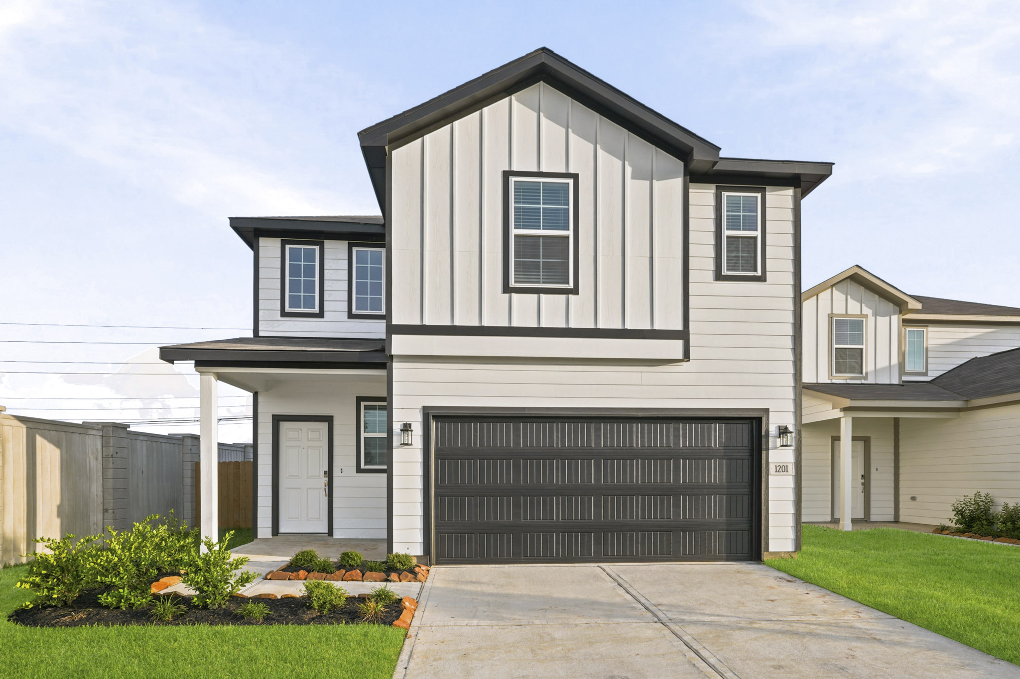 A grey house with a garage.