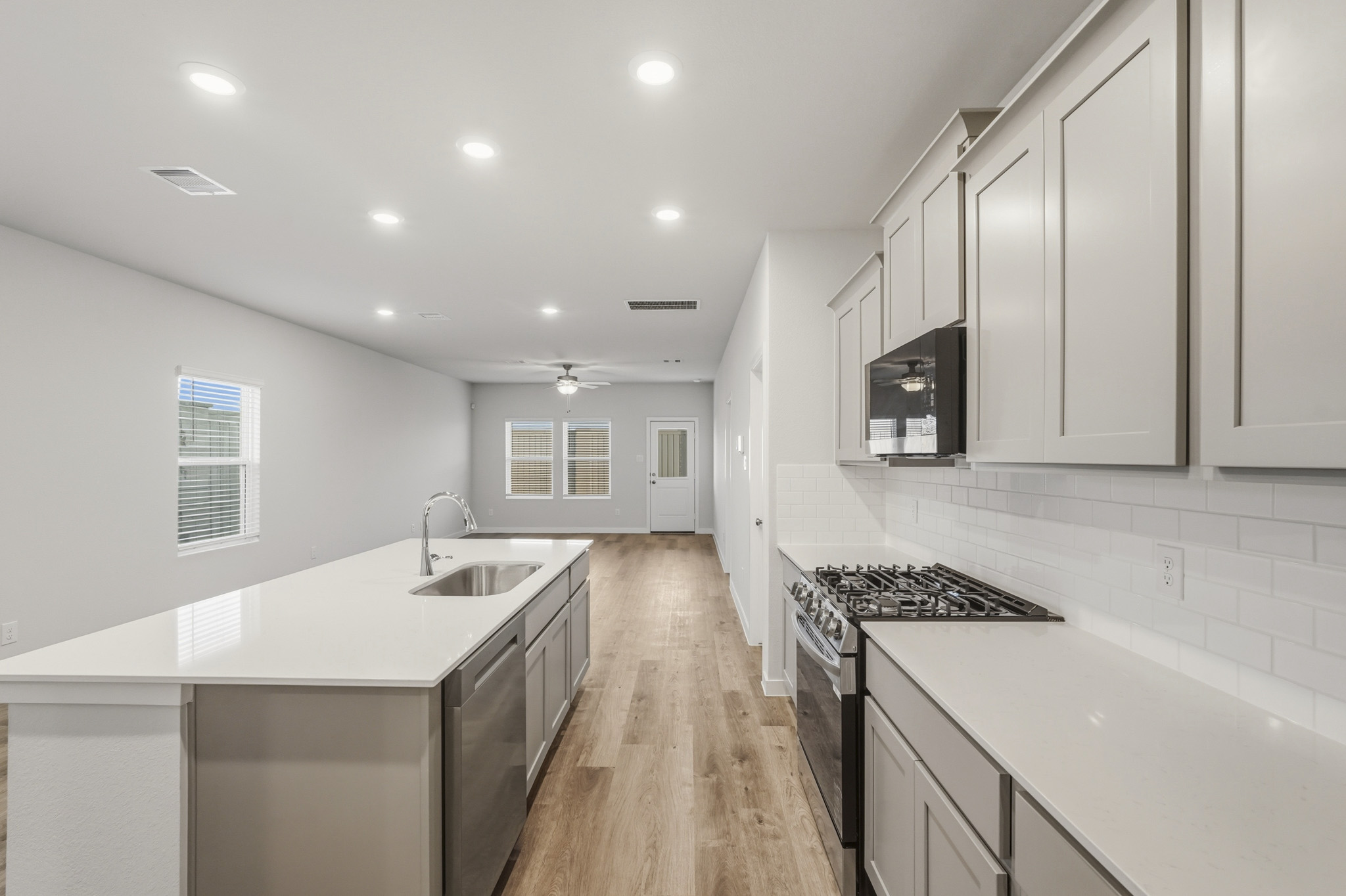 A kitchen with white cabinets.