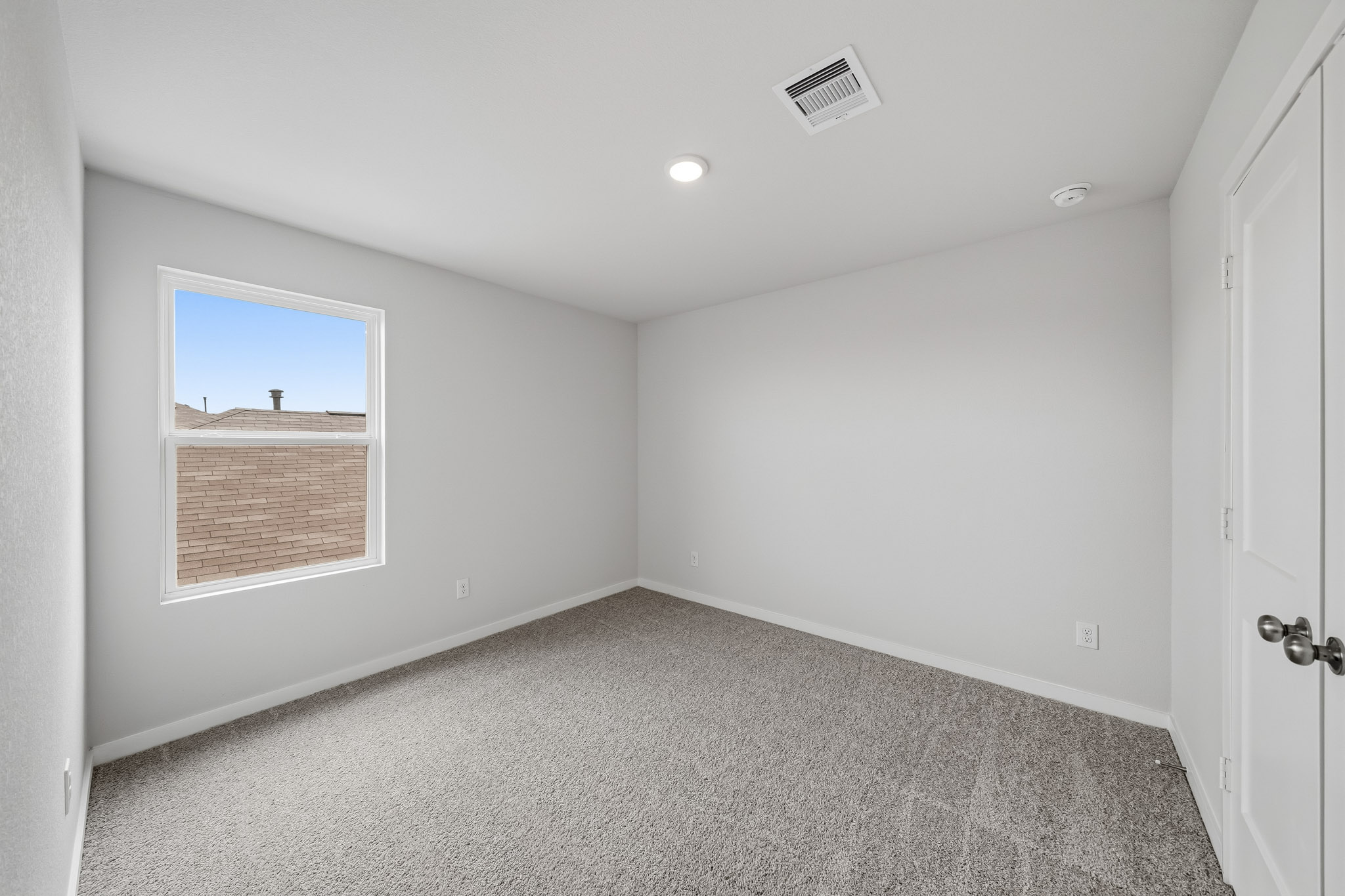 A room with a window and a door.