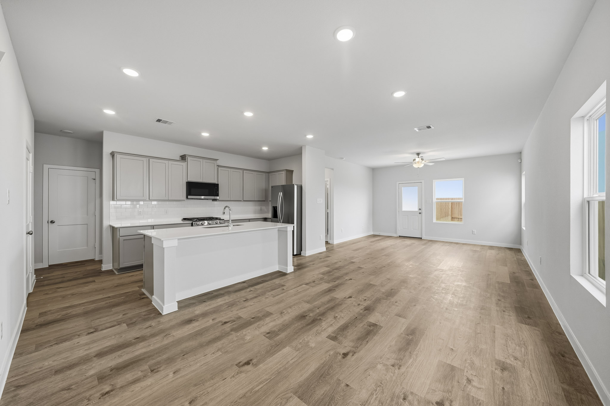 A kitchen with white cabinets.