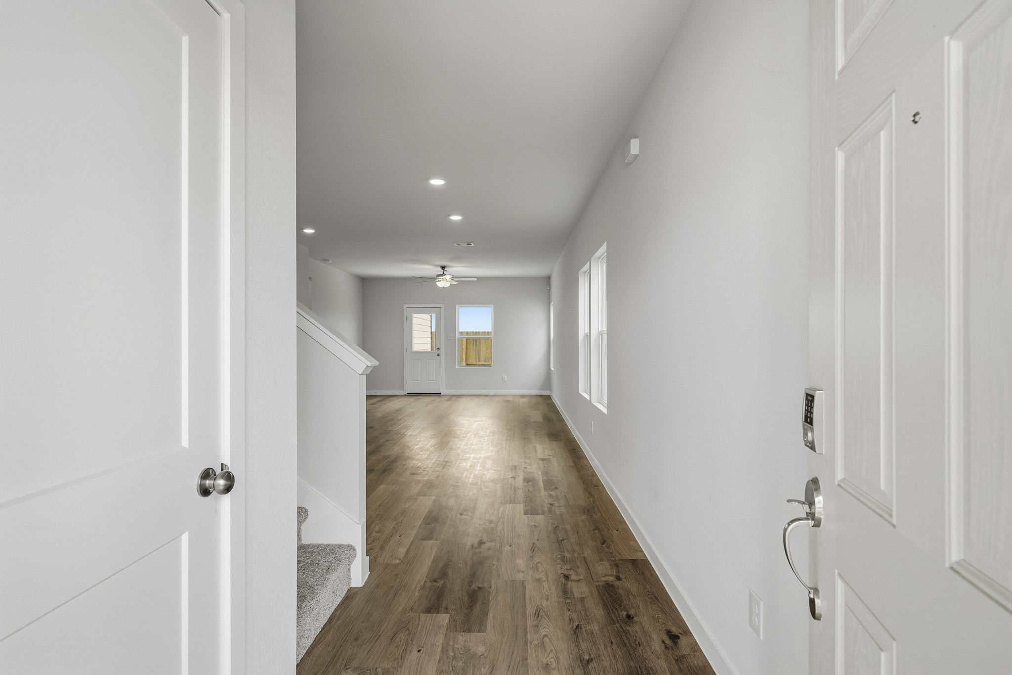 A hallway with white doors.