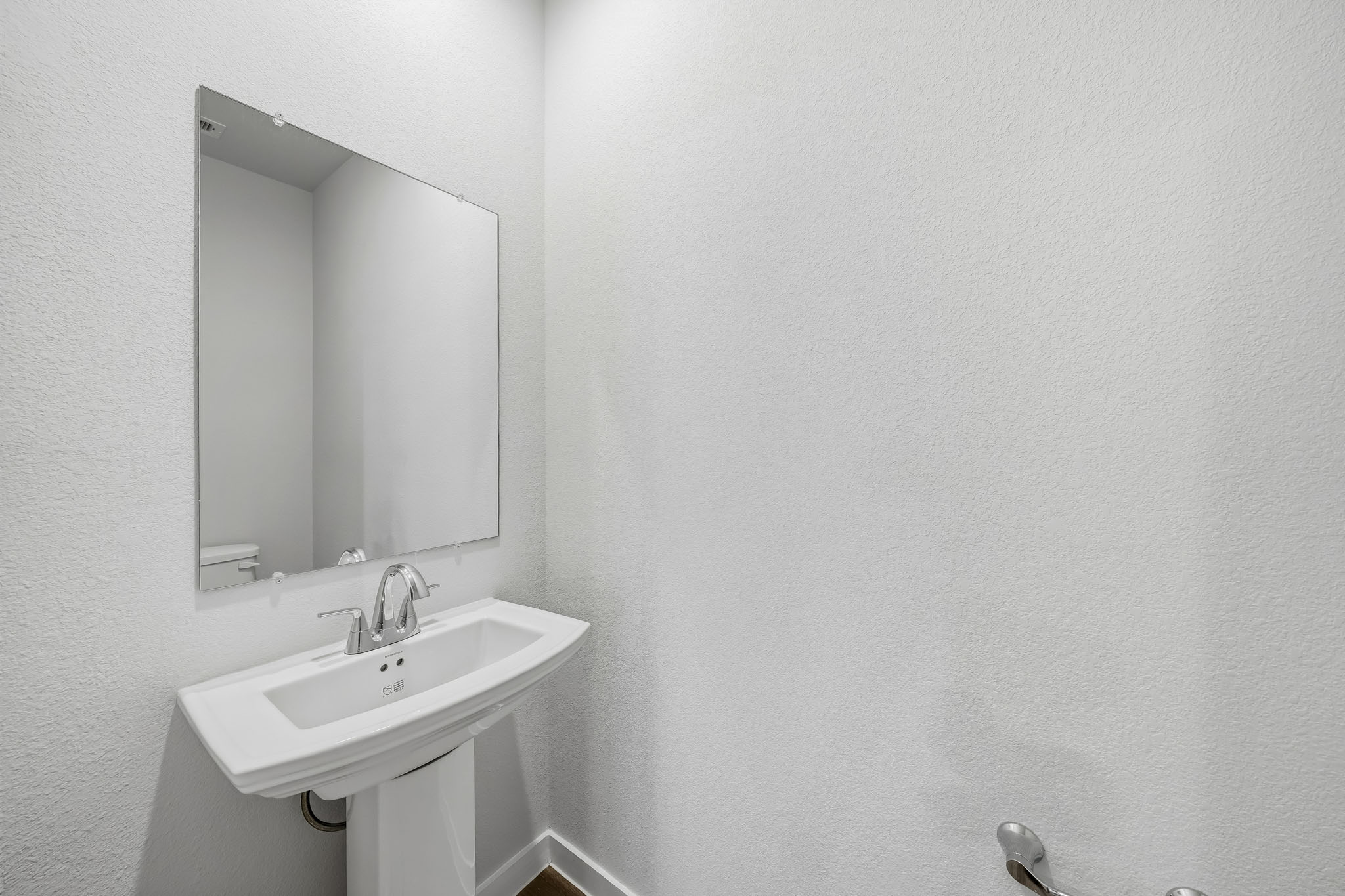 A bathroom with a mirror and sink.