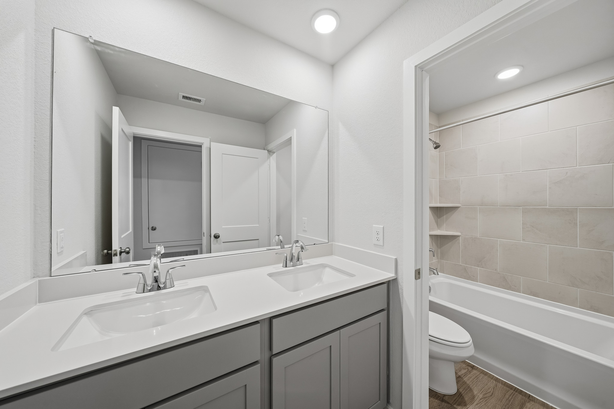 A bathroom with a tub sink and toilet.