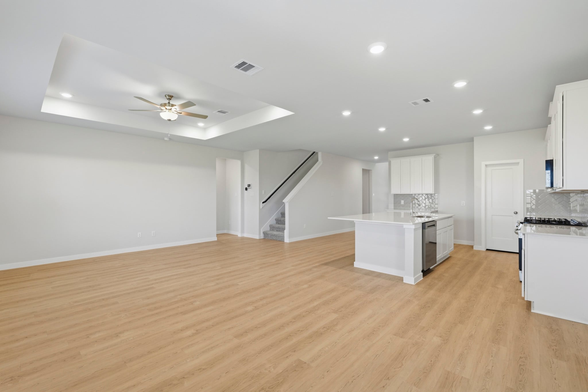 A large kitchen with white cabinets.