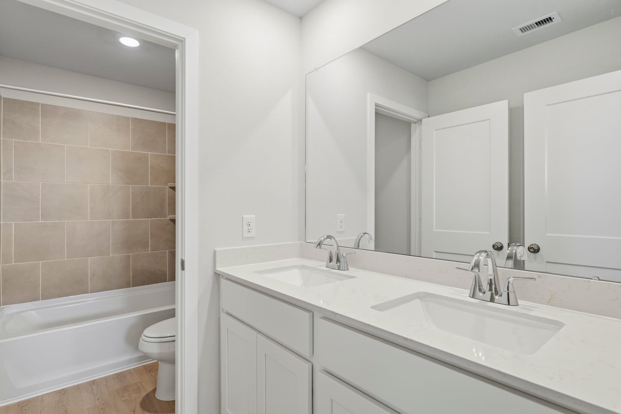 A bathroom with a tub sink and toilet.
