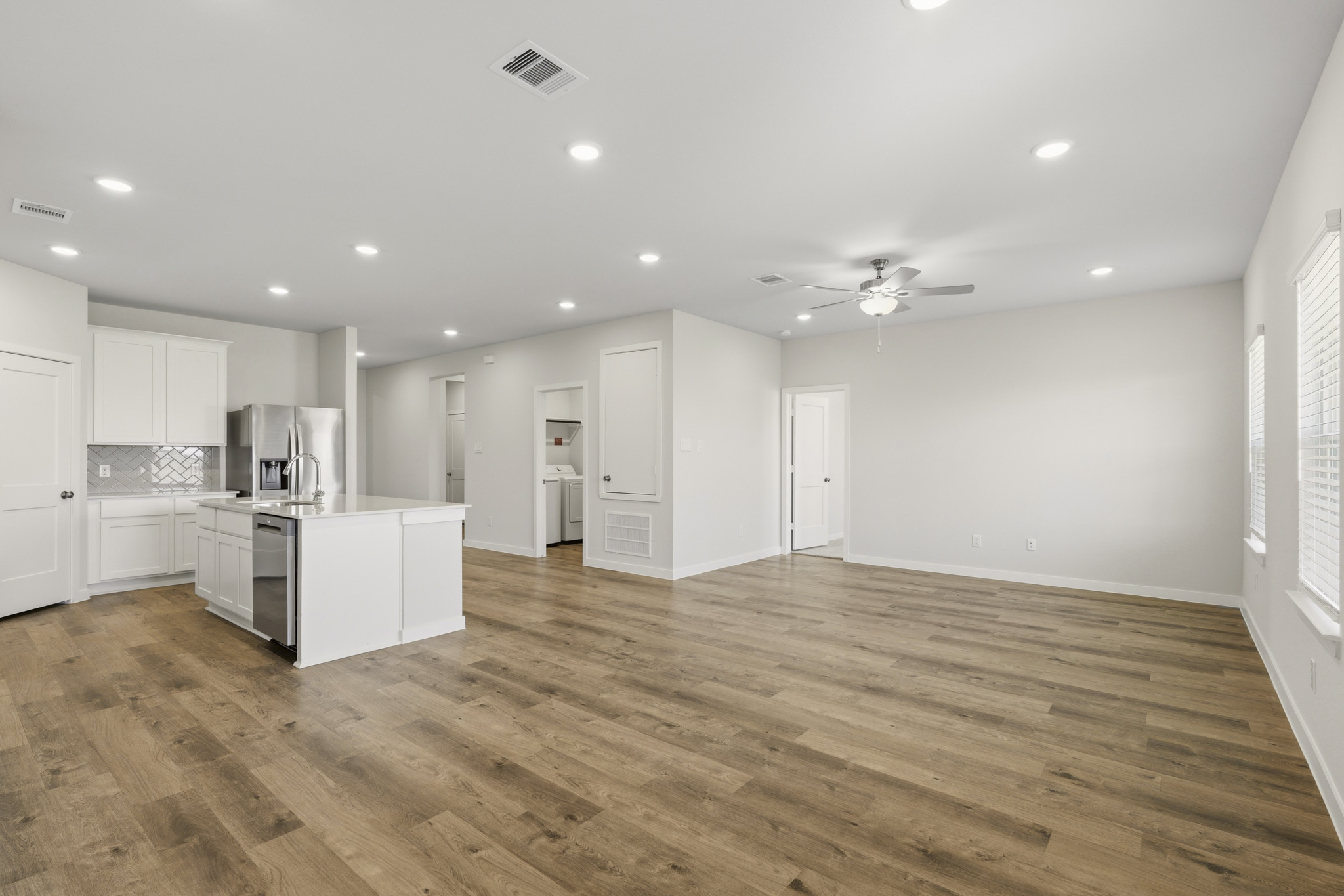A large kitchen with white cabinets.