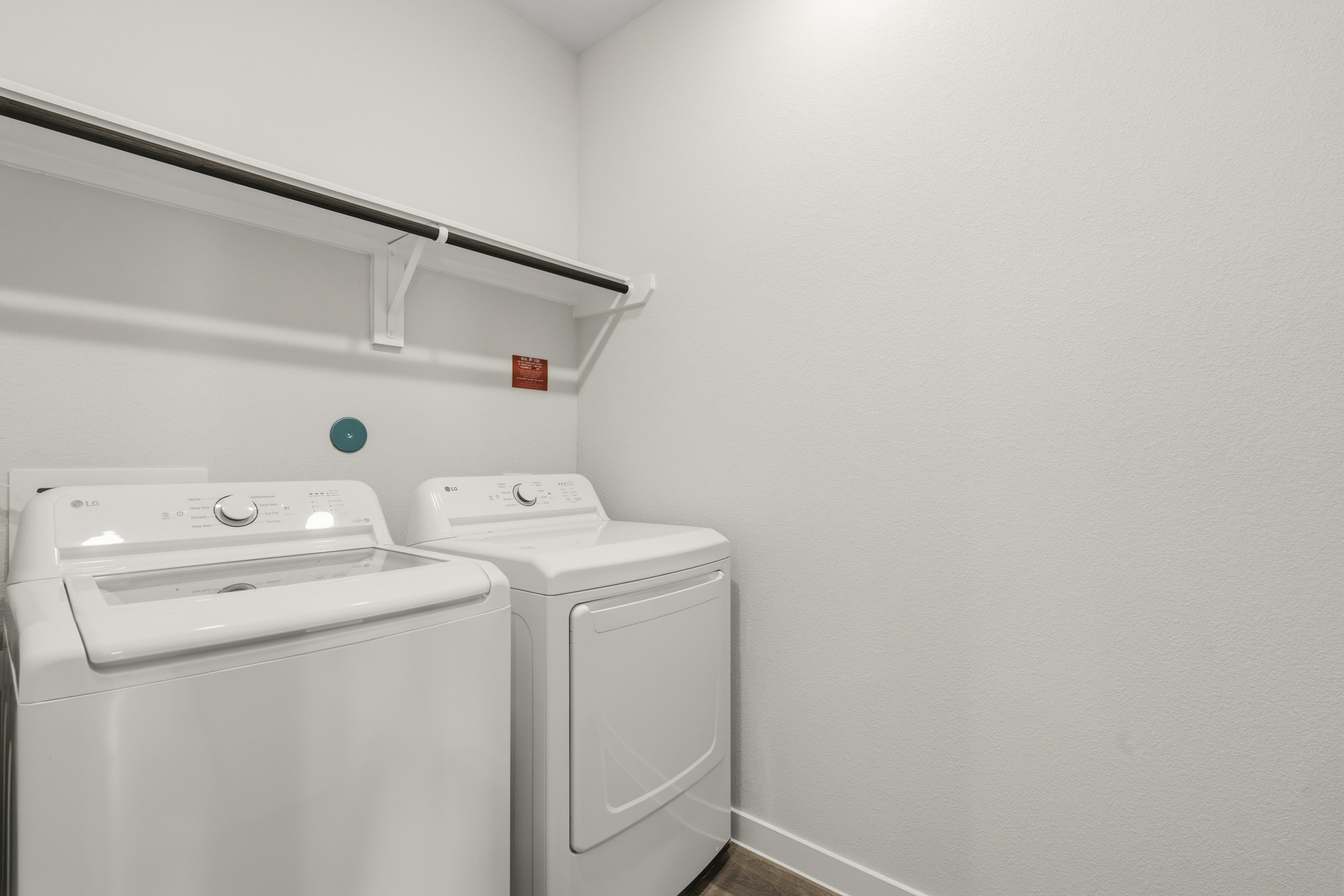A washing machine and dryer in a room.