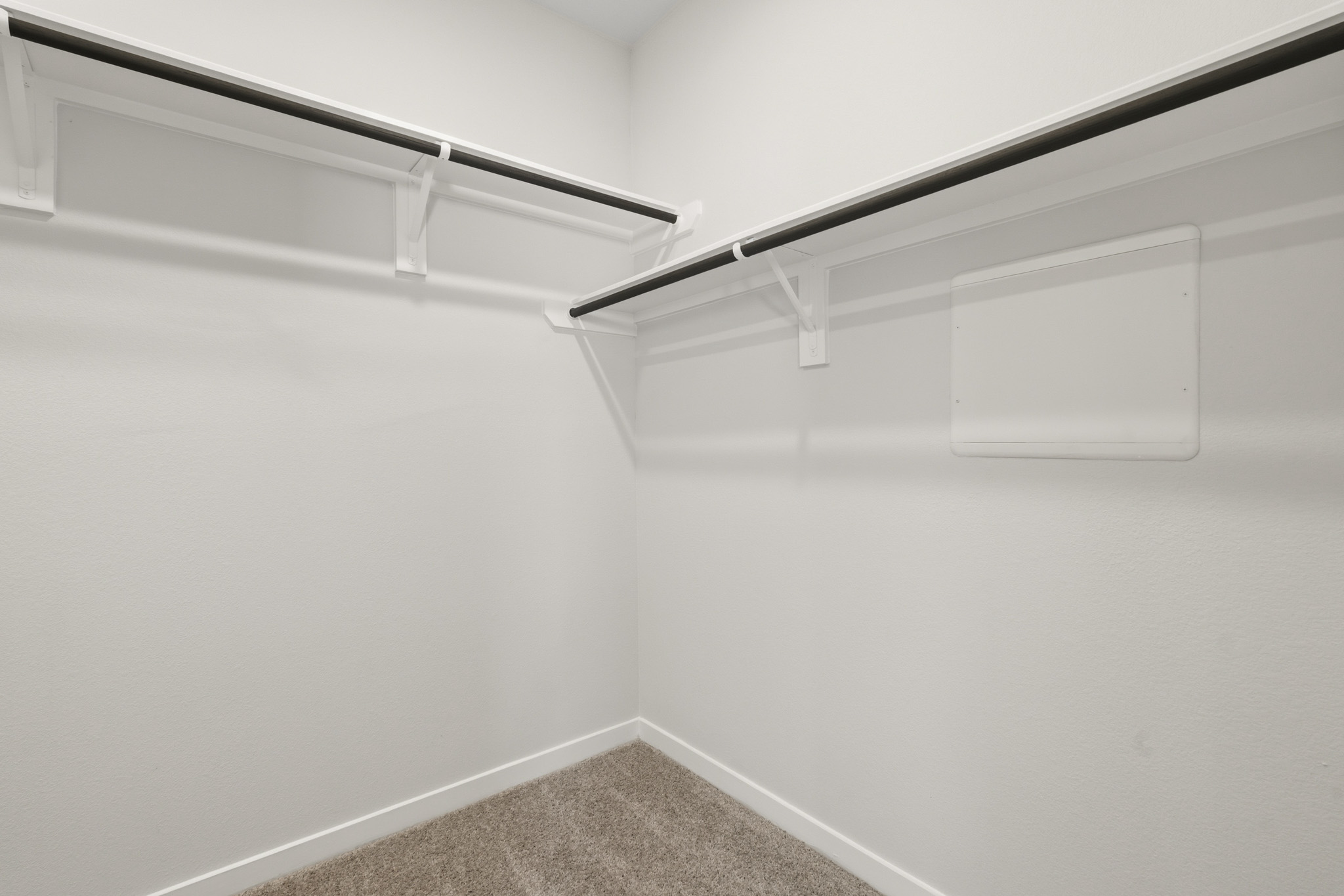 A white wall with a metal railing.